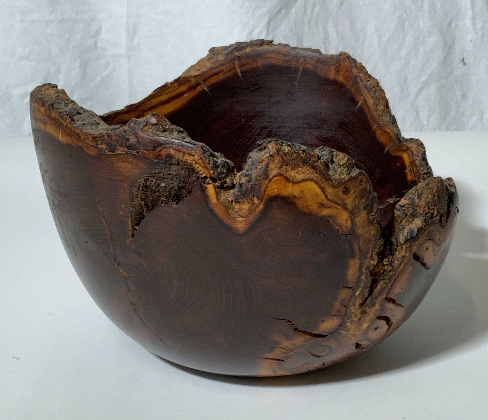Natural Mulberry Wood Bowl, New Zealand: A Natural Wood carved bowl by Woodturner, Greg Morris, c. 2000. Tree age lines visible throughout with natural wooden rim around bowl. Artist signature in verso, reads ‘New Zealand Mulberry, Greg Mo