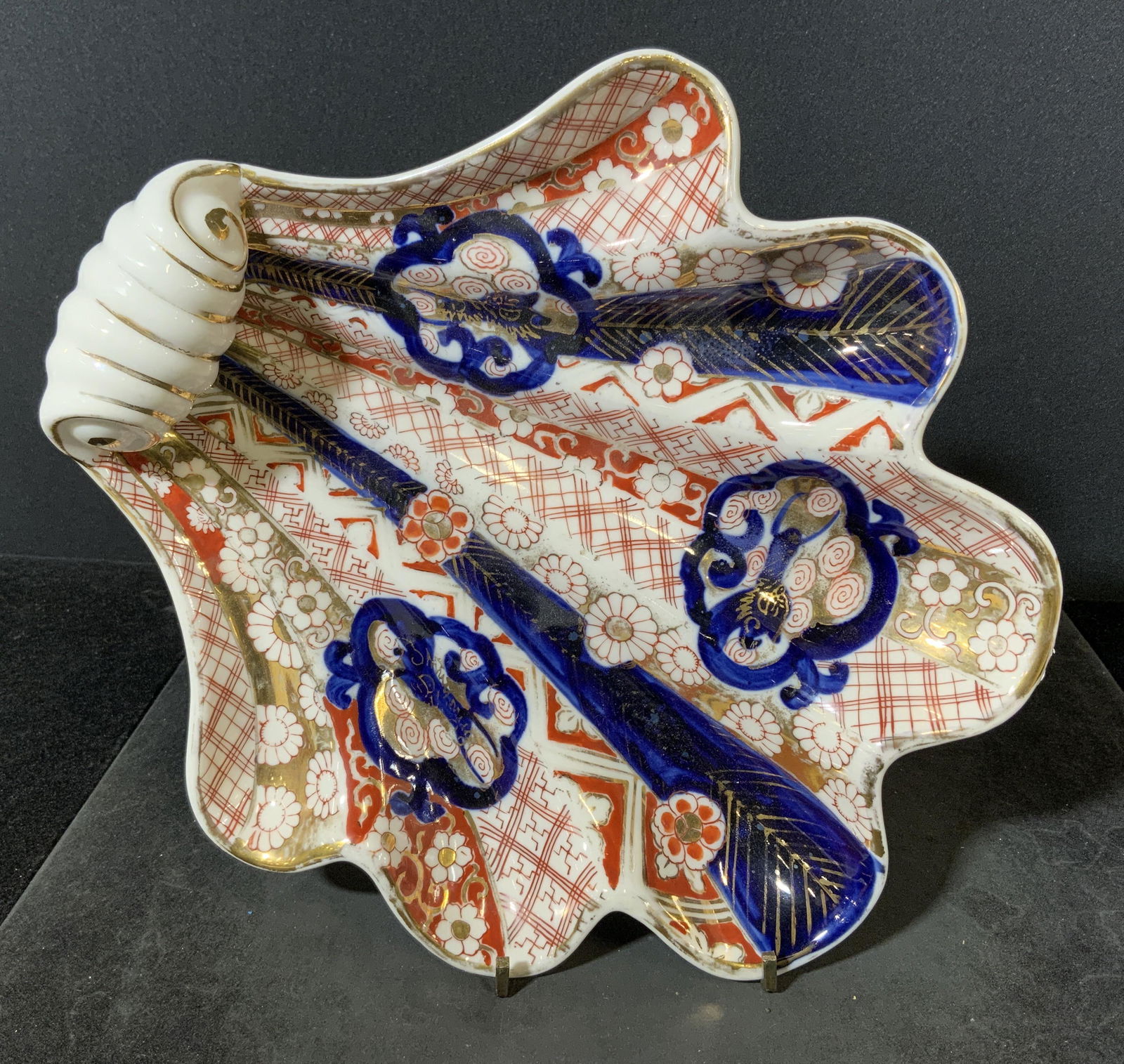 Hand Painted HOKUTOSHA Porcelain Dish, Japan: Hand painted dish, resembles a scallop shell. Underside reads as HOKUTOSHA MADE IN OCCUPIED JAPAN. Wear is consistent with age and use, wear to paint. Measures approx 10 inches h and 9 inches w. Home