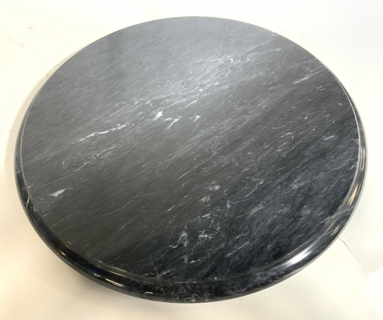 Circular Marble Place Tray Condiment Tray: Place tray is dark slate toned and marble. Piece is footed. Tray is circular shaped. Piece measures approx 14 inches wide. Place tray, condiment tray, marble tray, circular tray, marble place tray, ta