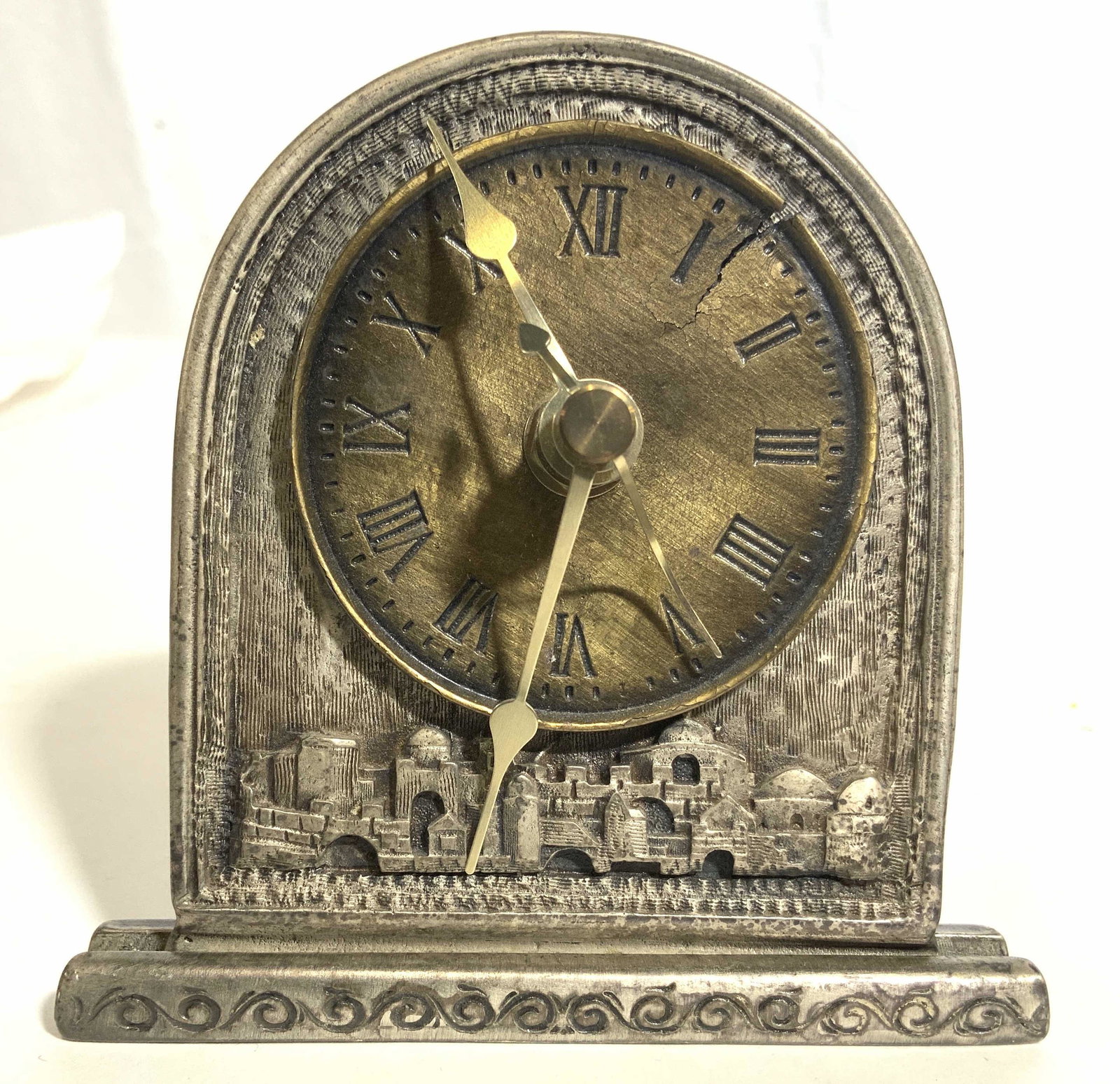 FIRST KEFTOR Judaica Desktop Clock: Backside of piece reads FIRST KEFTOR 03-5441567. Backside also has Hebrew characters. Piece is silver toned and metal. Clock face is gold toned with Roman numeral. Piece measures approx 4.5 inches tal
