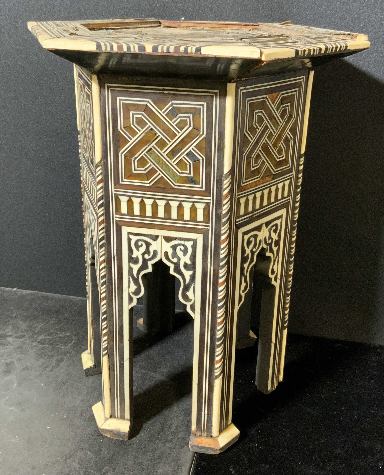 Antique Handmade Indian Style Plant Stand: Antique hand made plant stand. Indian style table, inlaid bone and multi toned wood decorate stand. Wear is consistent with age and use, loss present, evidence of repair. Measures approx 10 inches h a