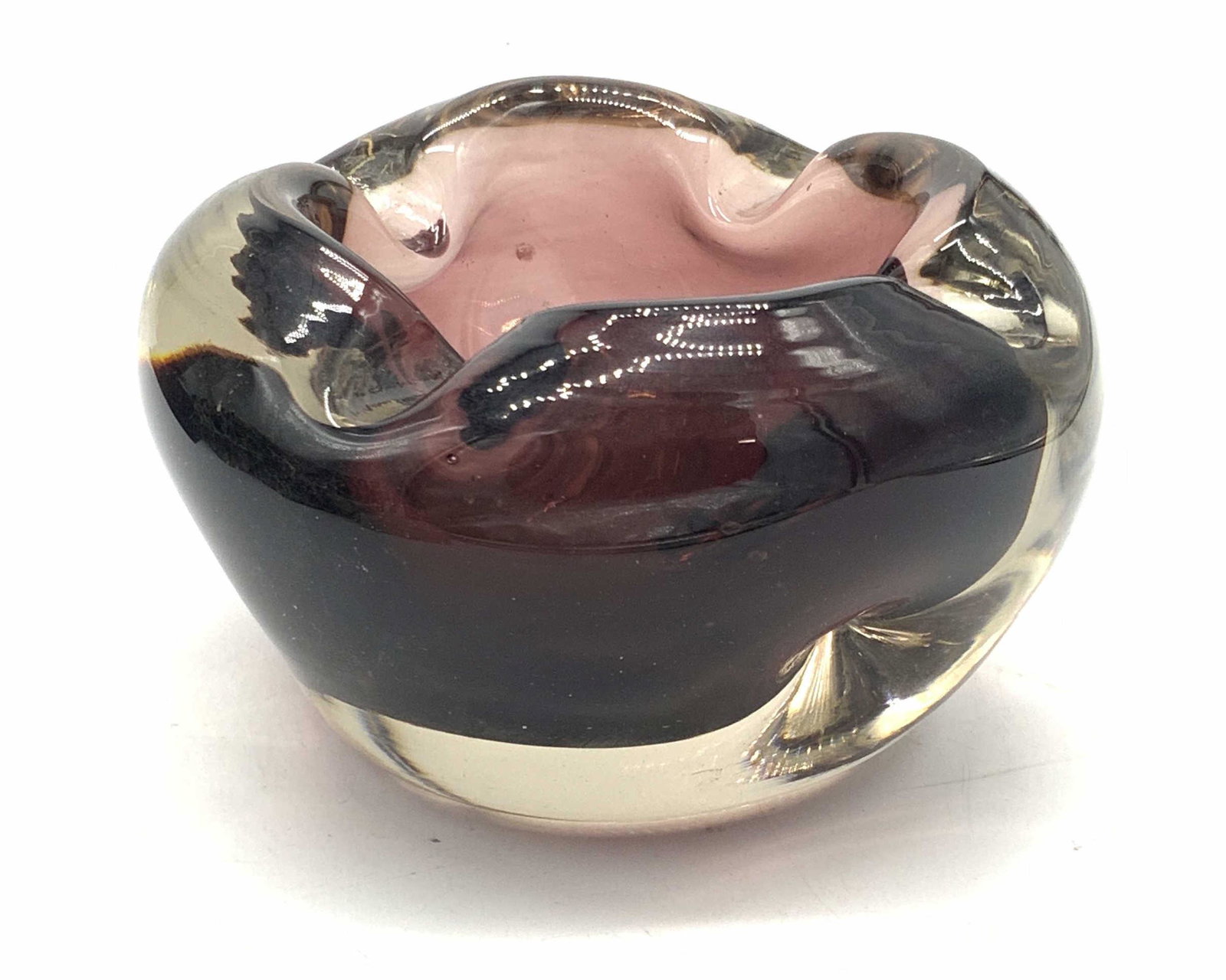 Vintage Crimped Art Glass Trinket Bowl: A vintage deep mauve hued art glass trinket bowl / ashtray with a crimped rim. Decorative indentations to the sides. Piece has some surface wear, surface scratches. Thick walled and weighty. Measures 