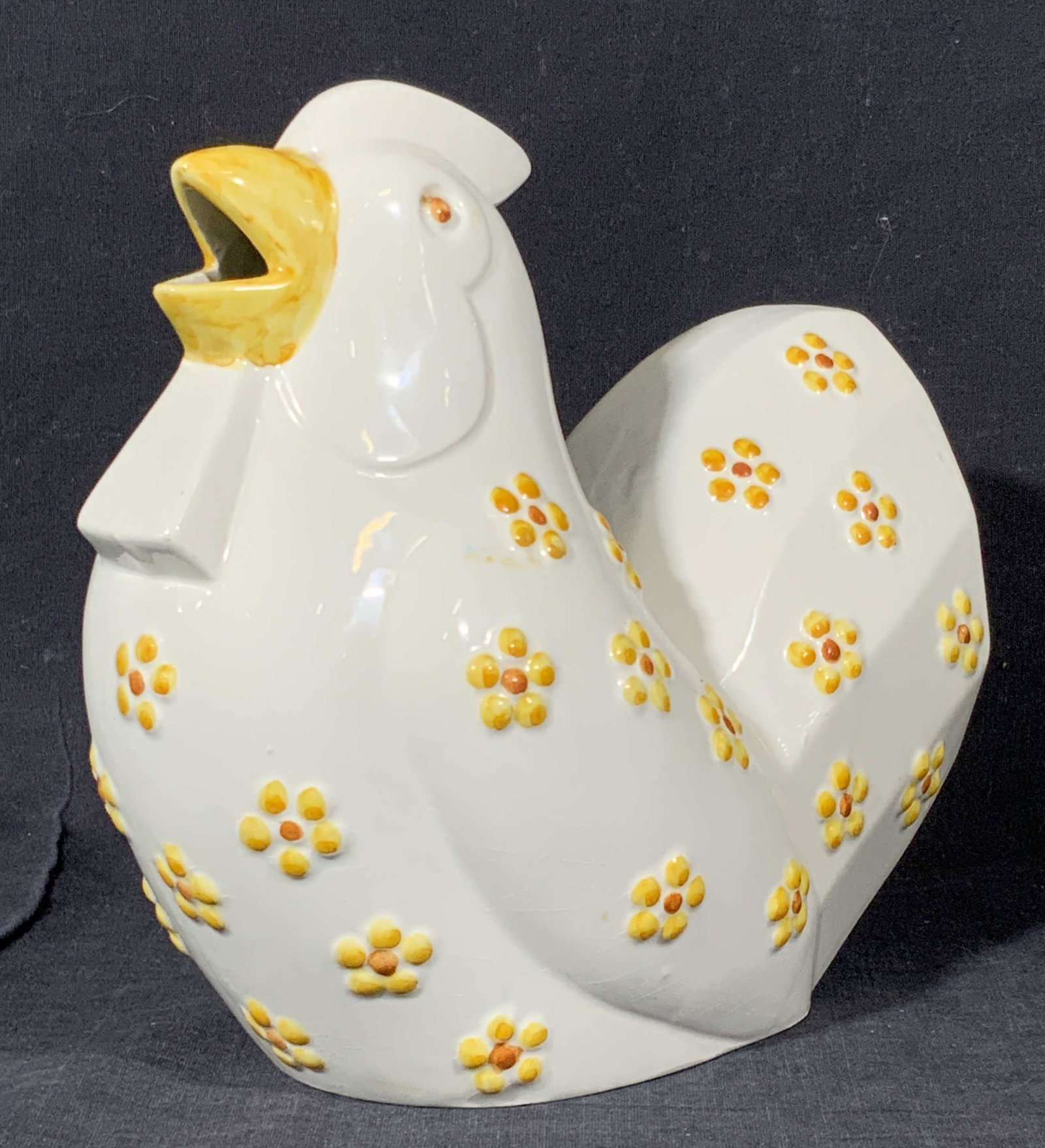 MOTTAHEDEH Signed Porcelain Chicken Figural: A white porcelain chicken with raised floral accents throughout the body. Hand painted with yellow and orange hues, Underside reads Made in Portugal. Sticker to underside reads MOTTAHEDEH Design. Vent