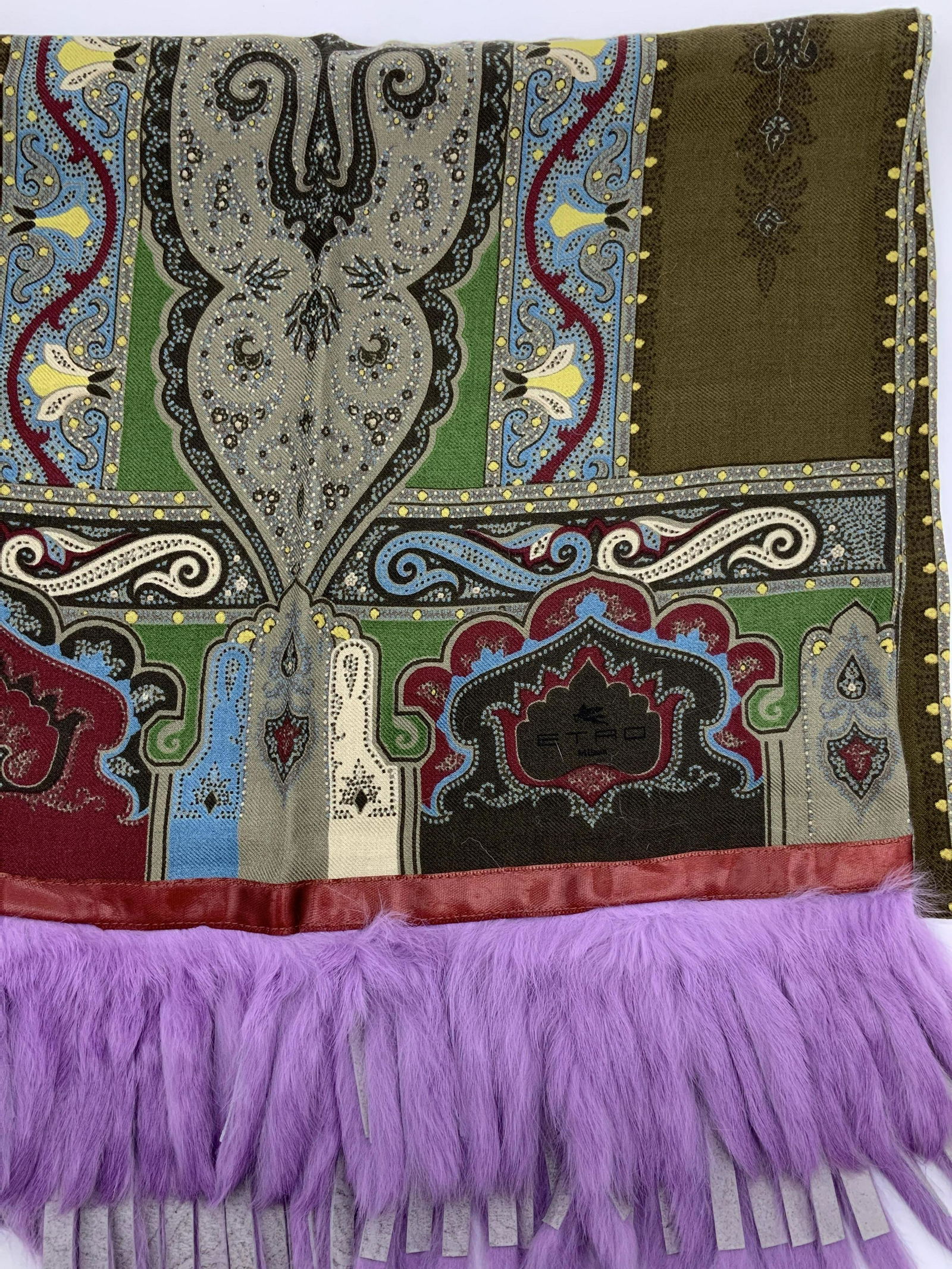 ETRO MILANO Long Wool Shawl w Fur Tassels: Double sided wool and silk shawl with East Asian scroll design and authentic fur tassels, dyed violet. Scarf color palette is moss green, burgundy, grey, yellow and sky blue. Measures 16.5 x 58 in. LA