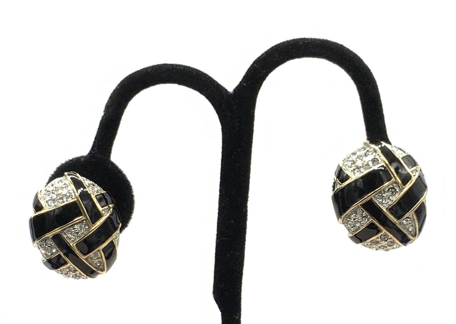 CAROLEE Diamonte W Black Enamel Cocktail Earrings: Oval Shaped Clip on Earrings with clear crystals crossed over with black enamel and outlined in polished gold tone metal. A classic cocktail party look. Earrings marked Carolee on clasp. 1 x .75 in. P