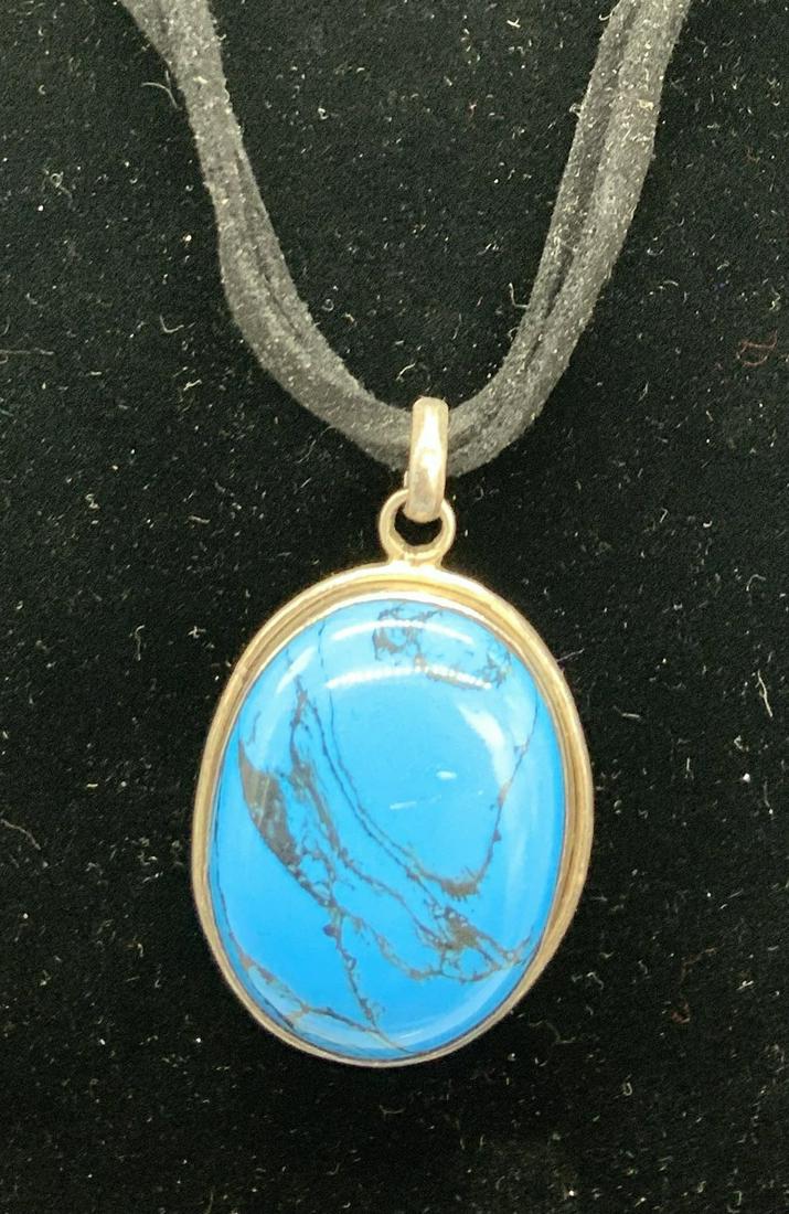 Turquoise Style Pendant Necklace set in Sterling: Princess length Necklace with black suede Rope, 15 in. App. Large faux turquoise cabochon set in sterling silver and marked 925. Bail is large on pendant to change to any style chain desired. Pendant 