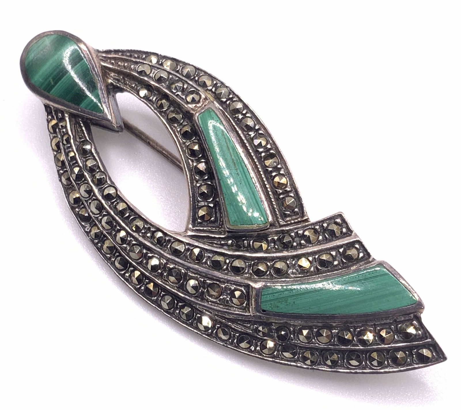 Vintage STERLING Malachite & Marcasite Brooch: A vintage sterling silver brooch with polished malachite stone and marcasite. Abstract form. Reverse possesses a metal pin closure. Marked 925 on reverse. Measures approx. 2L x 1W in. Total weight .31