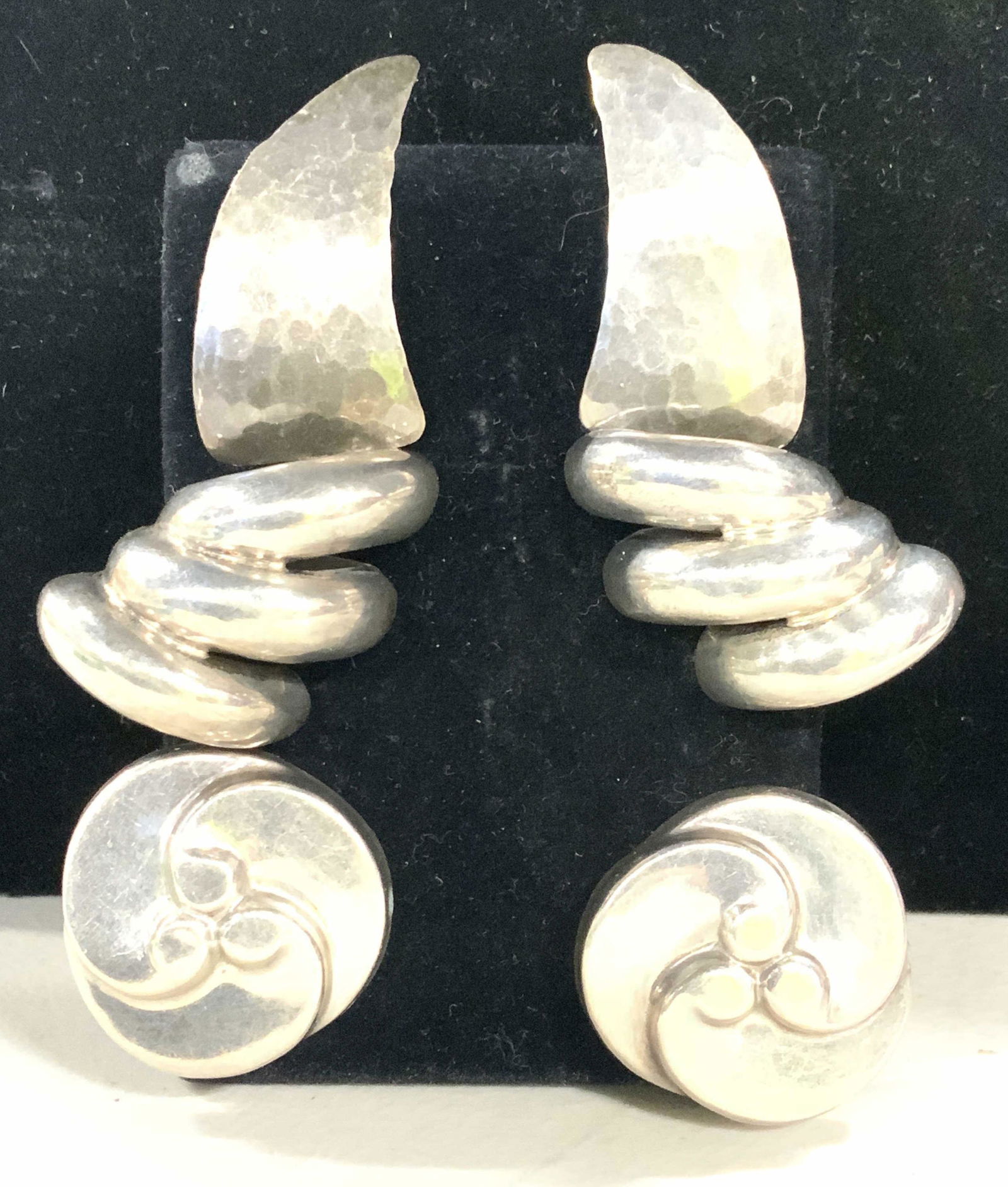 3 pair Sterling Silver Cocktail Earrings: Vintage Silver Earrings, 2 pair are clip on, one of those is Mexican Sterling , marked, other pair marked OLC 925. Avg size 1 in. 3 rd pair are for pierced ears, hammered silver 1.25 in. Long. 1.54 oz