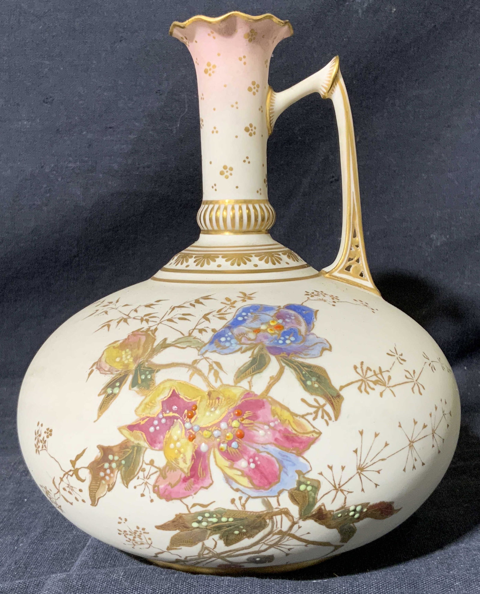 Porcelain Handled Vase with Tapered Neck: Porcelain Handled Vase with Tapered Neck, crown hallmark to underside, subject a cream colored China vase with gold toned detail and colorful floral detail, measures 6 x 6 x 6 1/2 inches, surface wear