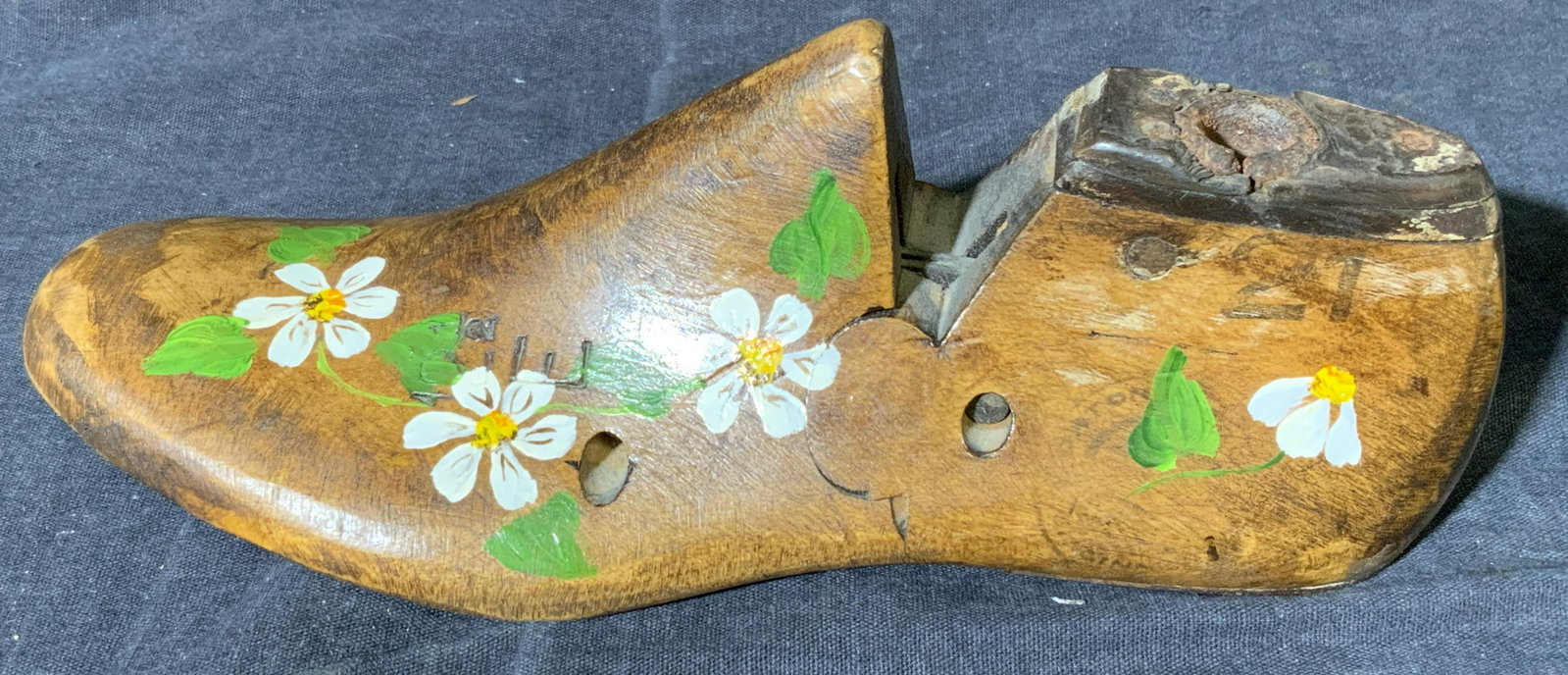 Wooden Cobbler Show Form W Handpainted florals: Wooden Cobbler Show Form, sticker to underside reads ‘GIBSONS montvale, New Jersey’, subject a wooden show form with a metal heel and flowers painted, measures 3 x 8 x 3 inches, surface wear to pi