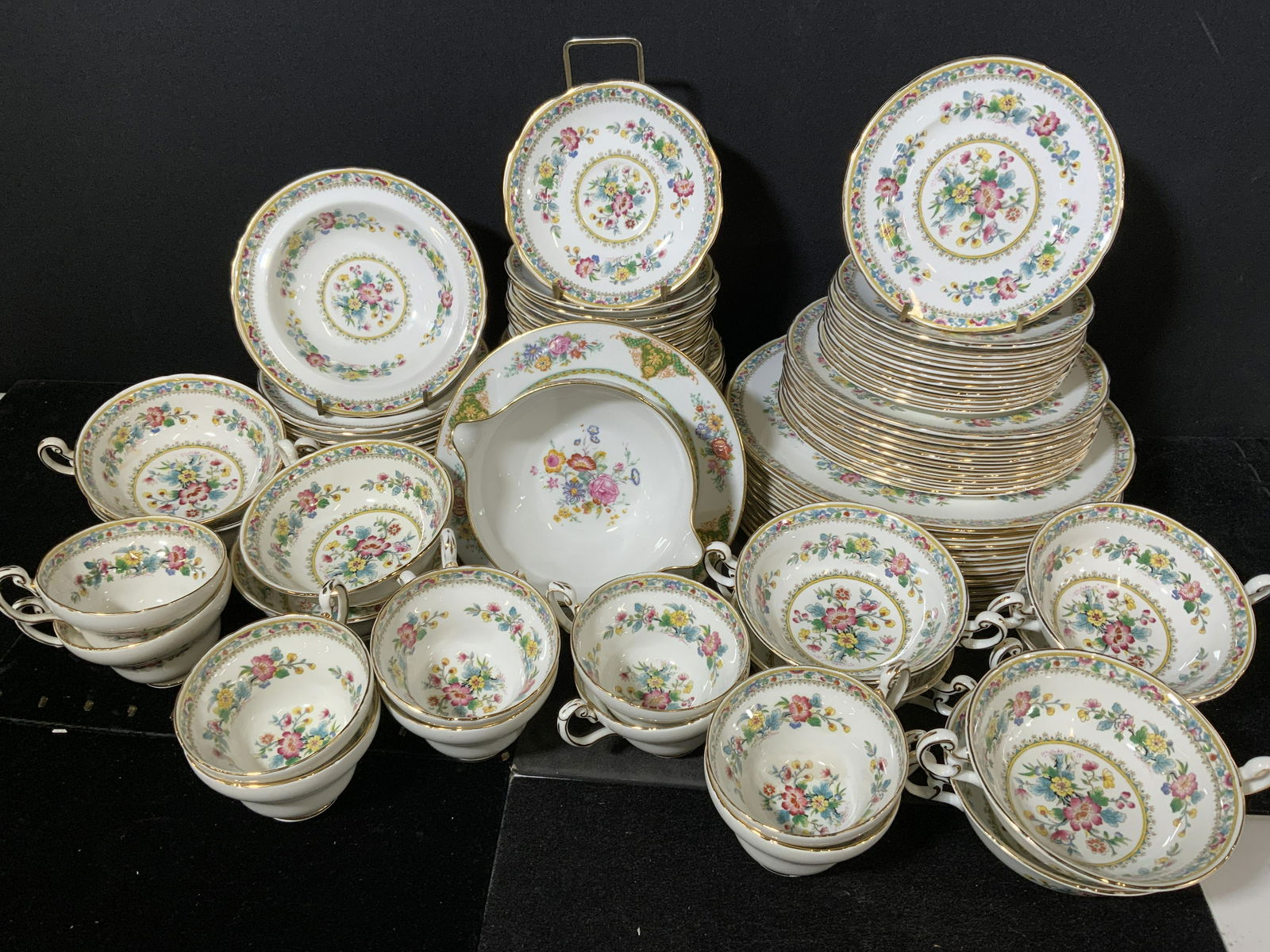 Group Lot FOLEY BONE CHINA Serving Set: 10 bouillon cups, 10 tea cups, 1 Double spout gravy boat, 12 dinner plates, 9 luncheon plates, 12 dessert plates, 24 saucers(two sizes), 12 bowls. Undersides read as FOLEY BONE CHINA 1850, EB, MADE IN