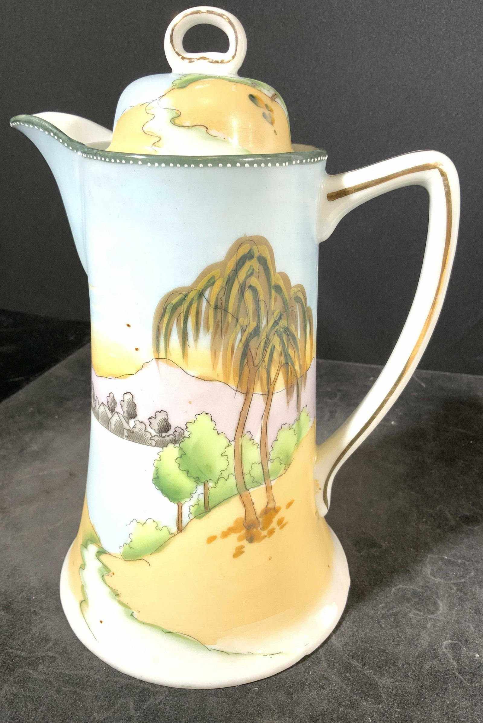 Vintage NIPPON Porcelain Coffee Pot W Lid: Underside of piece is marked NIPPON. Coffee pot is porcelain & includes lid. Piece appears to possibly be hand painted. Coffee pot measures approx 9 inches tall 6.5 inches deep 5 inches wide. Coffee p