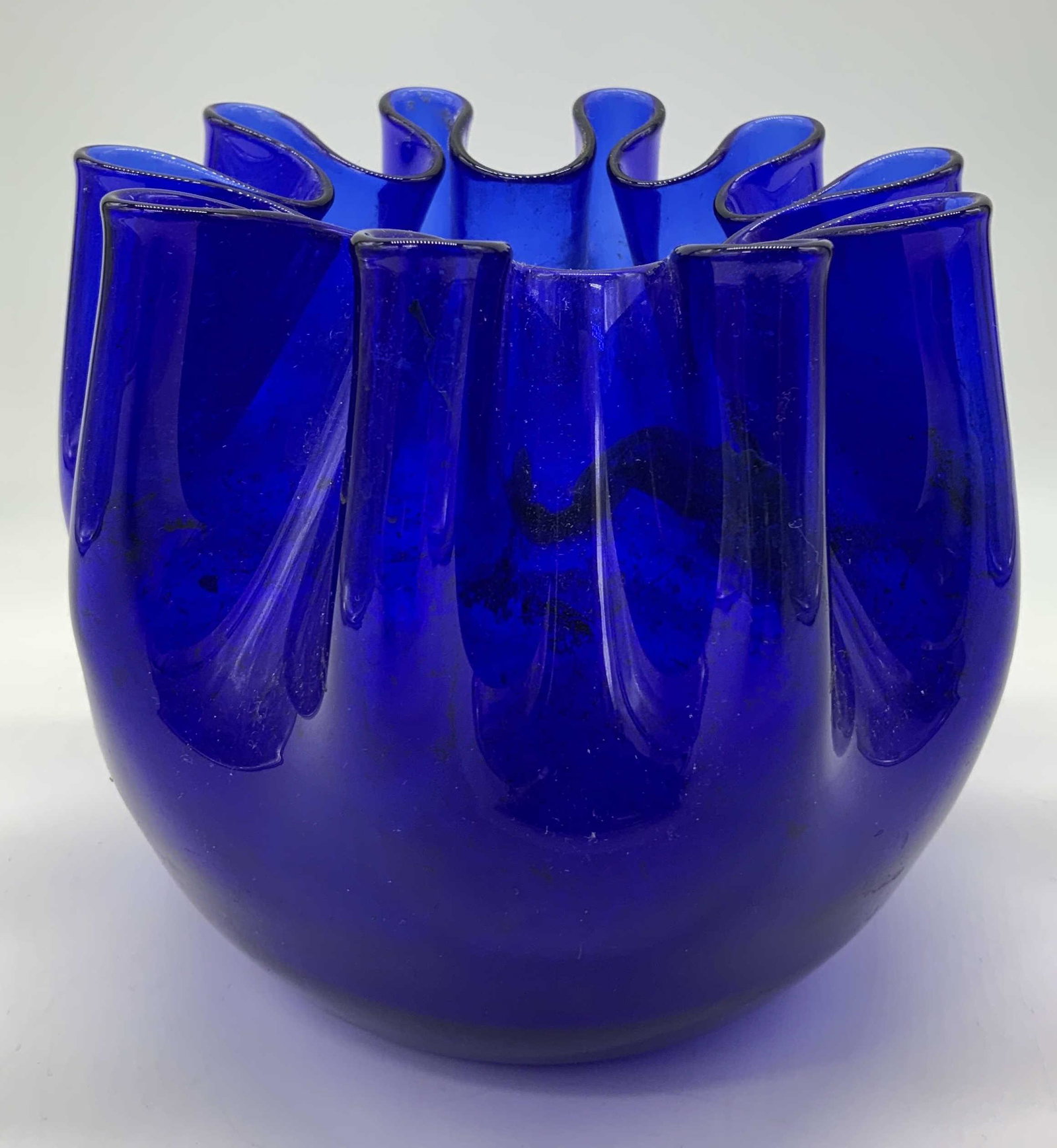 Blue Art Glass Vessel with Folded Rim: Blue Art Glass Vessel with Folded Rim, no apparent inscriptions or mark to piece, subject a blue toned glass vessel with a folded rim, measures 5 1/2 x 6 x 6 inches, surface wear to piece. Artwork, fi