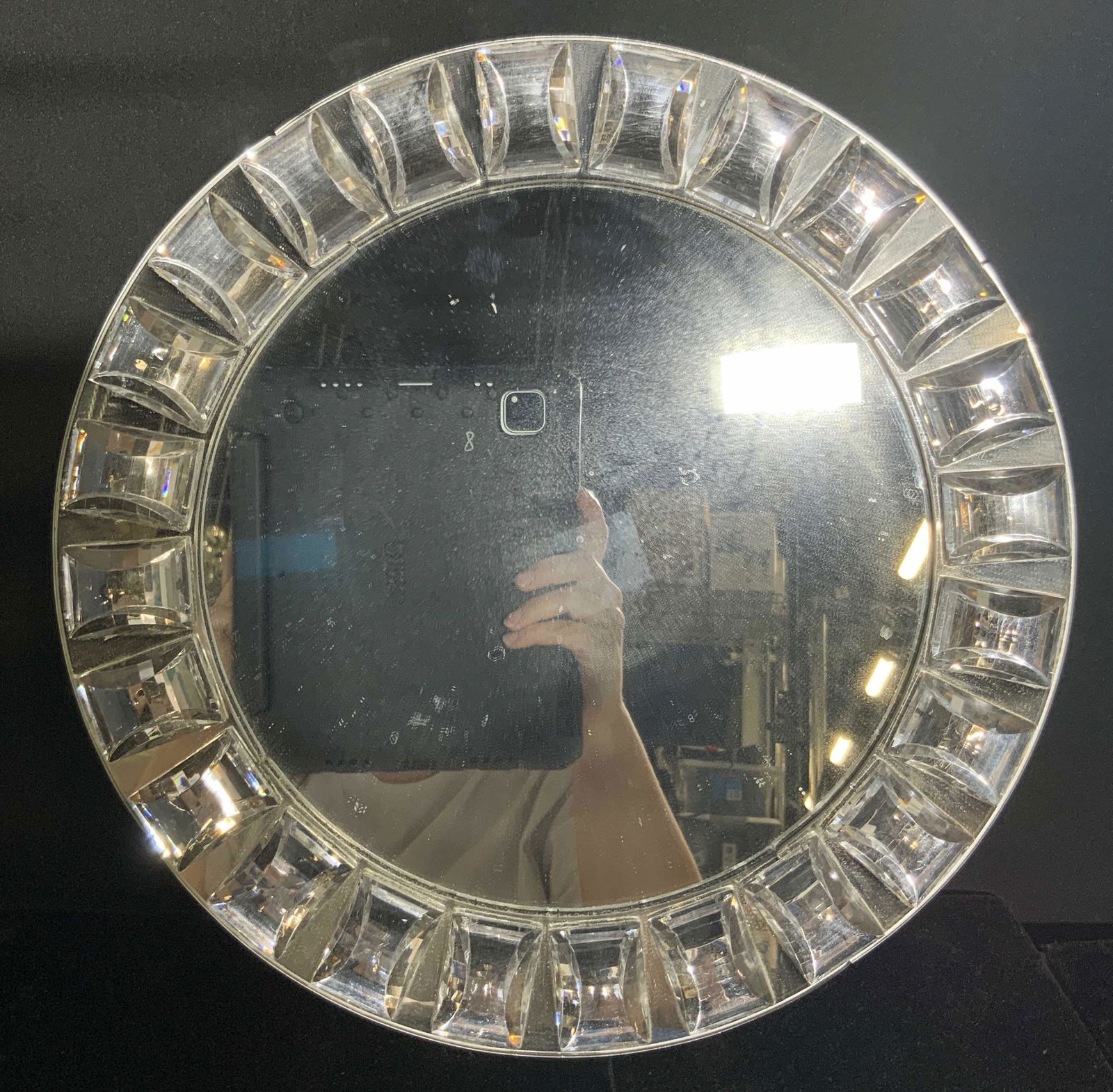 CHARGE IT by JAY Bejeweled Circular Wall Mirror: A circular wall mirror decorated with rectangular faceted rhinestones. Measures approx 13L x 13W in. Reverse possesses a sticker that reads CHARGE IT BY JAY. Some surface wear to piece, some chips and