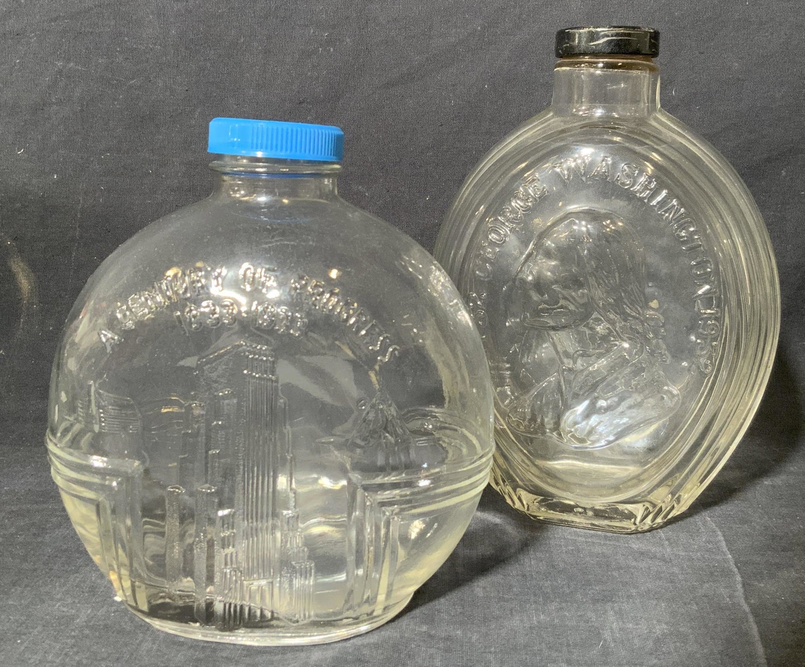 Vintage Historical Decorative Glass Bottles: Vintage Decorative Glass Bottles, glasses have inscriptions, blue capped glass reads ‘A Century of Progress’, black capped glass reads ‘1732 George Washington 1932’, blue cap measures 5 3/4 x 