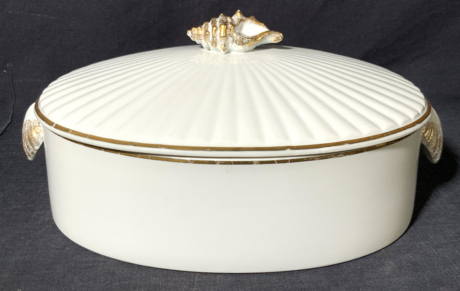 SHAFFORD CO. Golden Sea Shell Porcelain Dish: A deep dish porcelain pot by the shafford co. With seashell Lid topper and handles, with a gold gilt rim along lid and dish. Underside is marked ‘Golden Sea Shell by The Shafford co. Oven-to- table