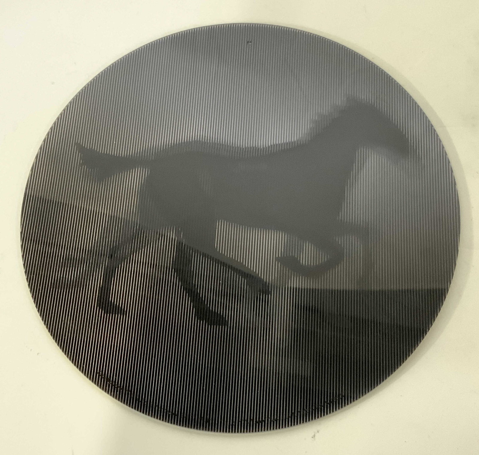 Black Lenticular Horse Wall Decoration: A black Horse Wall Decoration with lenticular/ picture changing depiction of a running horse. Marked ‘CineSpinner Rufus Butler Seder, Eye Ink. ‘ Measures 11 x 11 in. Some scratching throughout pie