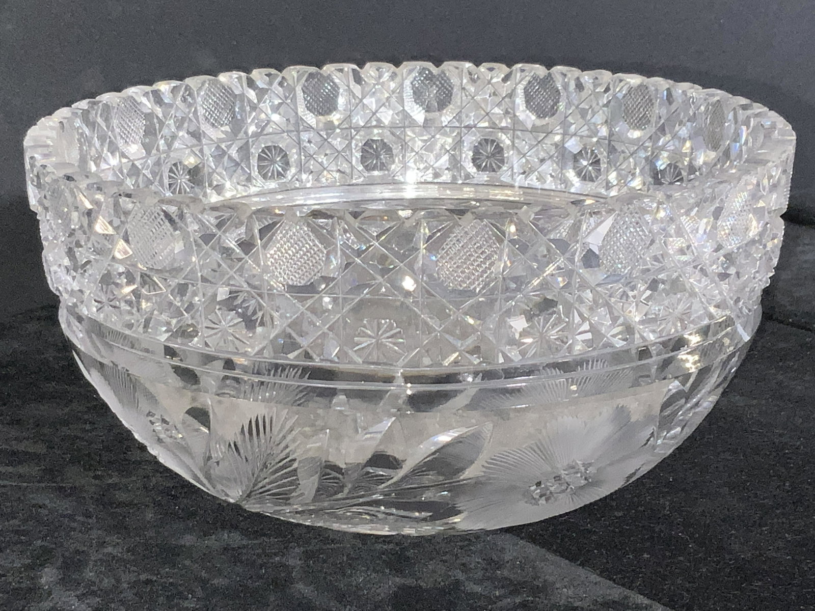 Vintage Cut Crystal Saw Tooth Bowl: A vintage cut and etched crystal sawtooth rimmed bowl. Florals throughout the design. Thick walled and weighty. Some chips to piece. Measures approx. 4H x 8W in. Vintage cut crystal, vintage crystal b
