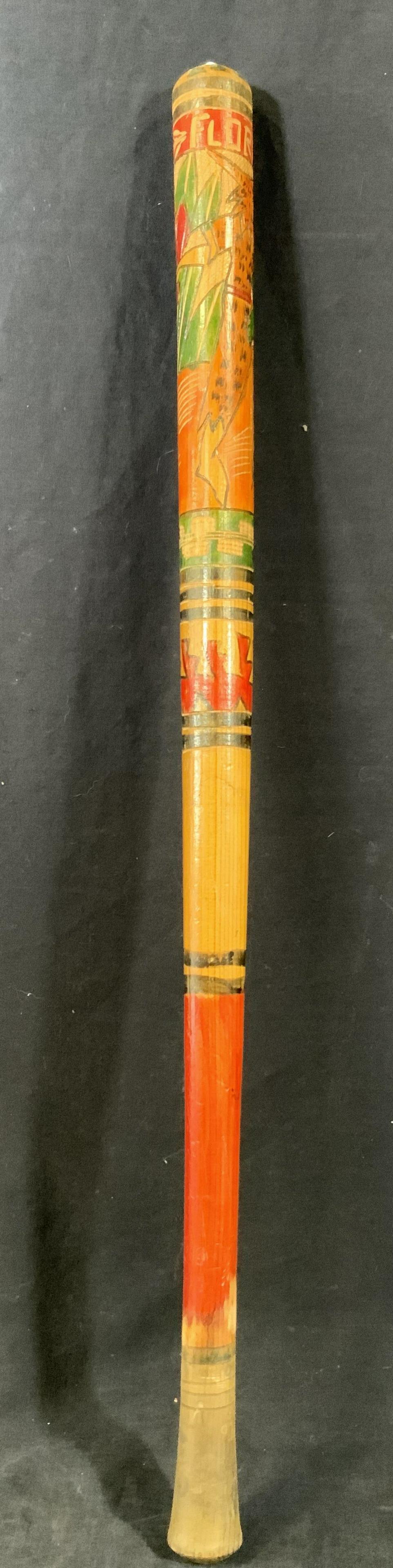 Vintage Hand Carved & Painted Florida Bat: A baseball bat that is carved into to read Florida, with Mexican art motifs in red & green and a depiction of a figure in an animal skin suit. Approximately 31 in long. Condition is consistent with ag