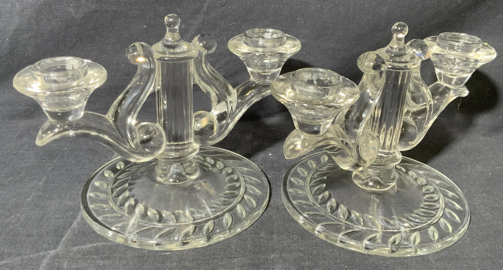 Pair Glass Double Candelabra: Pair Glass Double Candelabra, no apparent inscriptions or mark to piece, cast glass candelabras with two candle holders each and foliage detail to base, measures 5 1/2 x 8 x 5 1/2 inches, surface wear