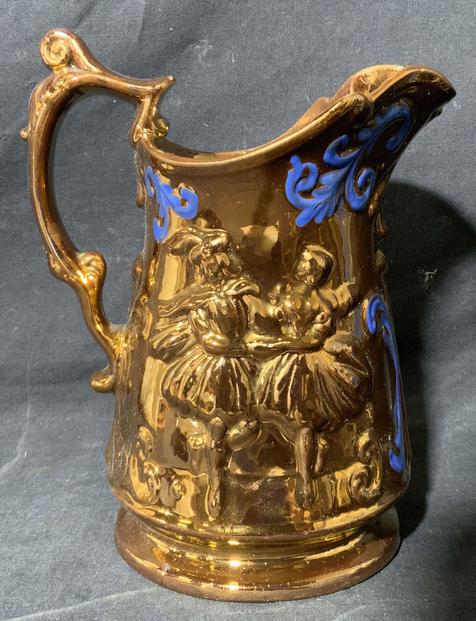 Lusterware pitcher with Blue Accents: Lusterware pitcher with Blue Accents, no apparent inscriptions or marks to piece, subject a Lusterware pitcher with white interior and blue accents to exterior, measures 8 x 6 x 4 1/2 inches, surface