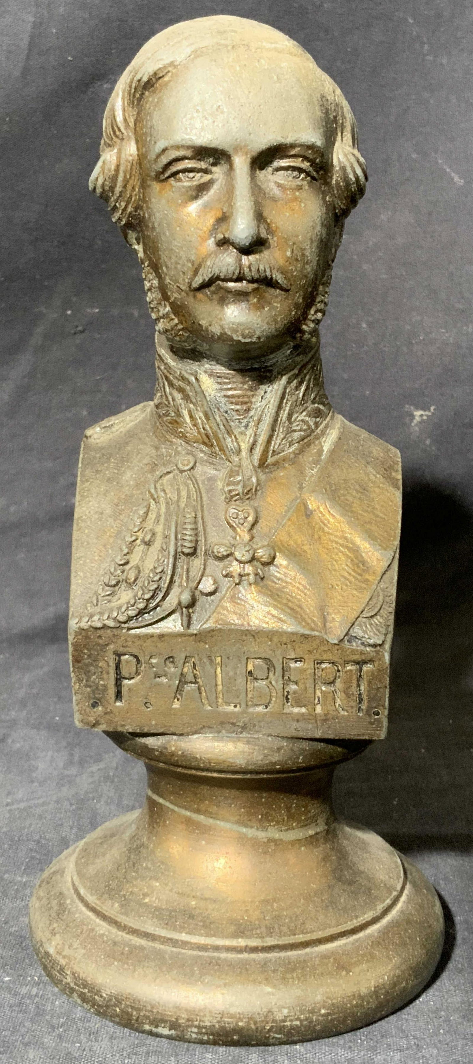 Metal Bust of P. Albert: Metal Bust of P. Albert, front of bust reads ‘ P. Albert’, subject a bust of the mustachioed P. Albert, measures 7 1/2 x 3 1/2 x 3 1/2 inches, surface wear to piece. Artwork, fine art, tabletop ar