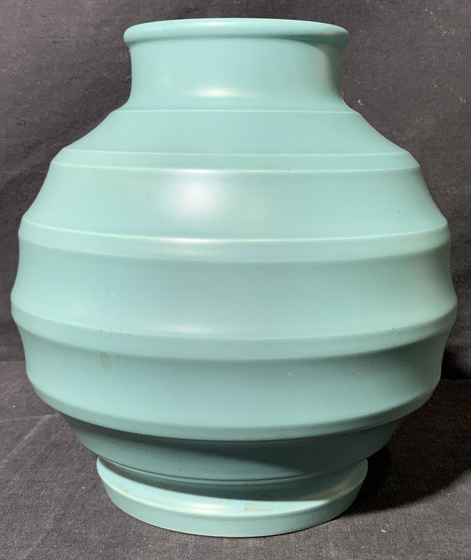 Vintage Keith Murray for Wedgwood Ribbed Vase: Vintage Keith Murray for Wedgwood Ribbed Vase, underside reads ‘KM WEDGWOOD’, subject a matte green toned ribbed vase, includes found article of similar vessels, Picture enclosed here, piece measu