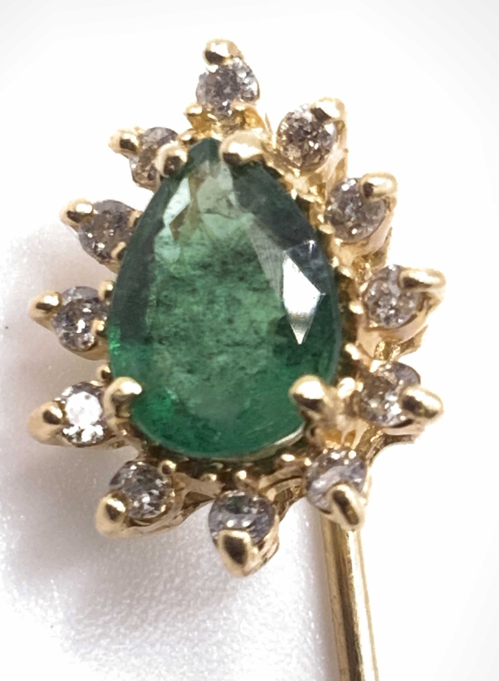 Vintage Green Tear Drop Crystal Sweater Pin: A vintage gold tone metal sweater pin decorated with a faceted green tear drop form crystal surround by colorless faceted crystals. Measures approx 2L x .25W in. Collectible jewelry, Vintage Jewelry, 