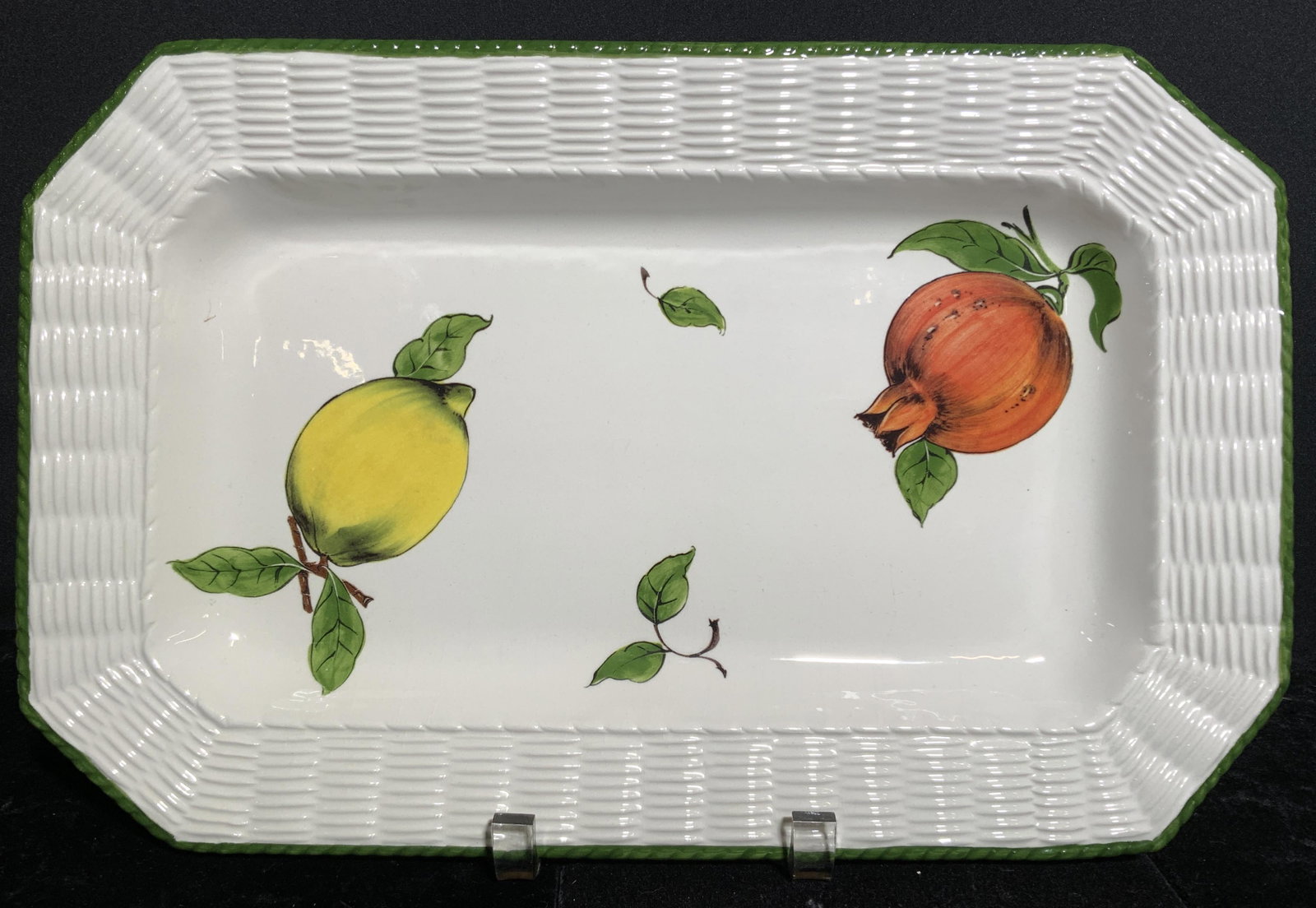 TIFFANY & CO Porcelain Fruit Platter: Underside of piece is marked TIFFANY & CO. Fruit platter is white toned and Porcelain . Piece has green toned rim. Piece depicts lemon and & pomegranate. Piece measures approx 16 inches long 10 inches