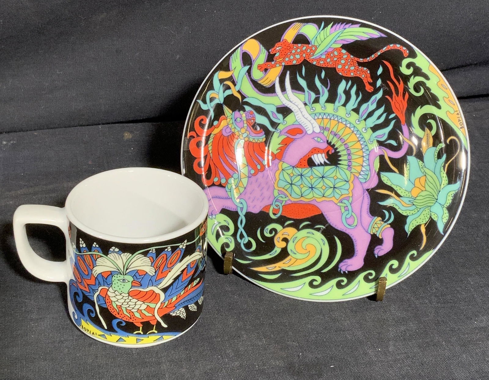 SWISS BOPLA Tea Cup & Saucer: SWISS BOPLA Tea Cup & Saucer with abstract bird and big cat motif, saucer measures 5 w x 5/8 h inches, cup measures 3 w x 2 1/8 inches, wear consistent with age and use. Teacup, decorative teacup, tea