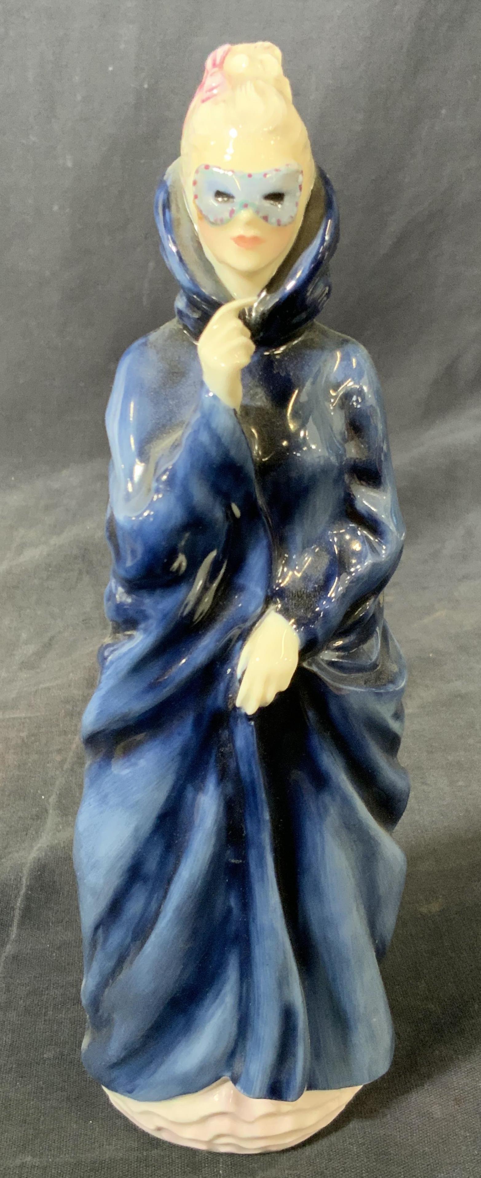 ROYAL DOULTON Porcelain Figural Masque: A fine bone porcelain figurine Hallmarked ‘Royal Doulton England’ on underside marked with the name ‘Masque H.N. 2554’ depicting a woman in a blue robe that covers her whole body besides her h