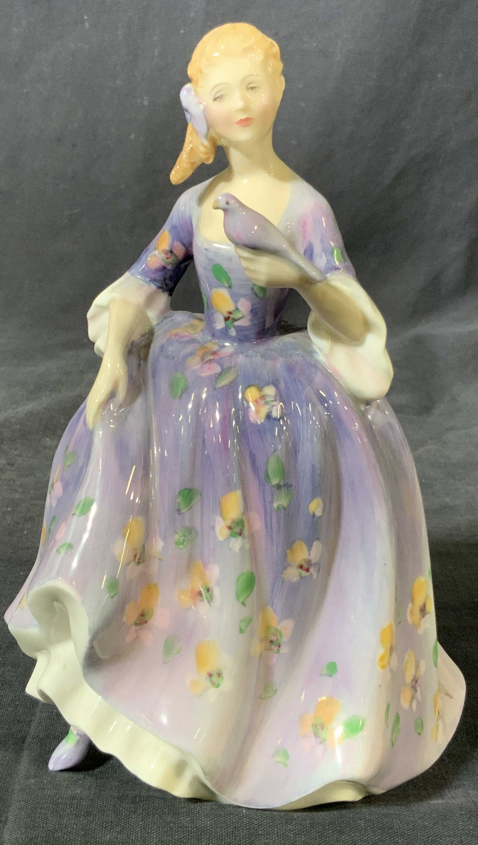 ROYAL DOULTON Porcelain Figurine Nicola: A fine bone porcelain figurine Hallmarked ‘Royal Doulton England’ on underside marked with the name ‘Masque H.N. 2554’ depicting a woman in a blue robe that covers her whole body besides her h