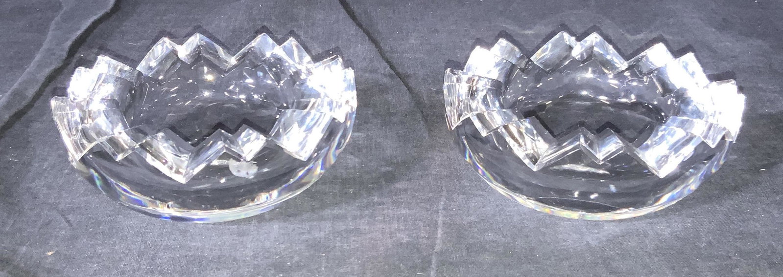 ROSENTHAL Set 2 Crystal Bowls, Germany: A set of 2 Rosenthal Studio Line cut crystal bowls, thick walled, with saw tooth rims. Trademarked ‘Rosenthal Studio Line’ on verso. Approximately 2 in H and 4.75 in W. Some sticker residue and ch