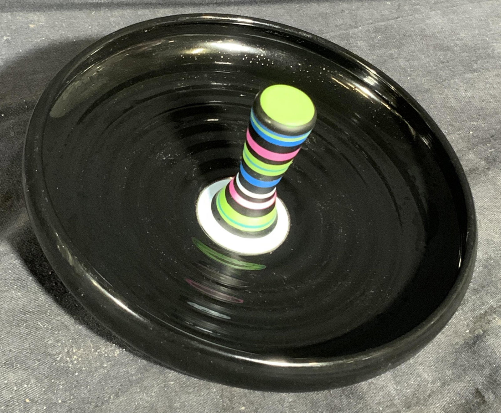 ALESSI F. GOORIS Piroutte Desk Organizer Toy: ALESSI F. GOORIS Piroutte Desk Organizer Toy, hallmark to base, Materials include thermoplastic resin and stainless steel colored with epoxy resin. Measurements: 6 inches in diameter x 2 7/8 inches he