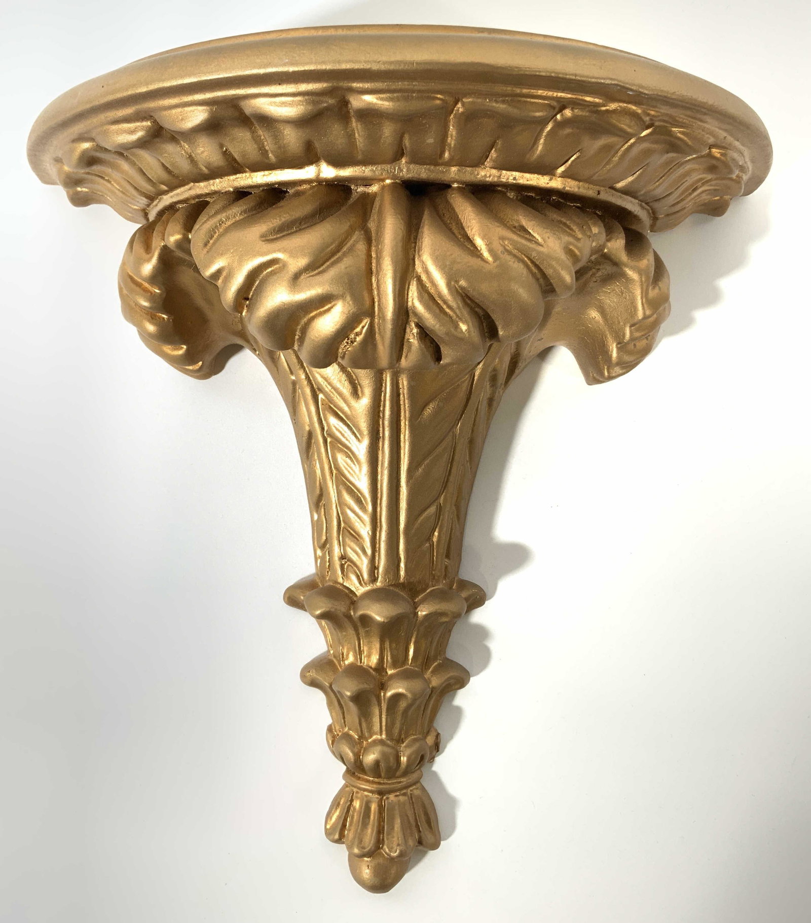 Ornate Italian Gilt Wood Wall Shelf: Backside is marked MADE IN ITALY. Piece has ornate structures & detail. Platform on top is semi circle shaped. Wall shelf appears to be gilt wood. Piece measures approx 11.5 inches tall & wide. Wall s