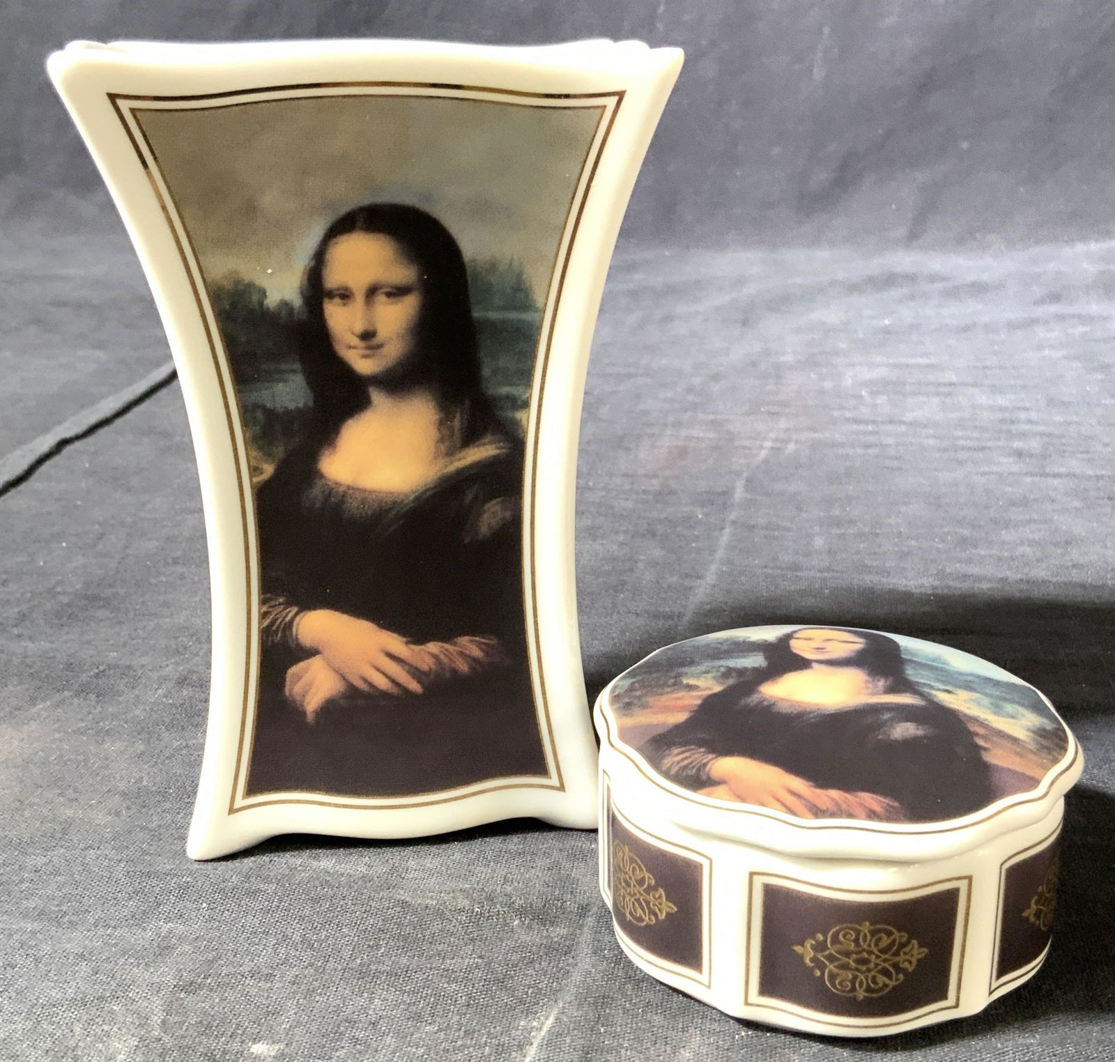 GOEBEL Artis Orbis Mona Lisa Vase & Box: A white porcelain vase and trinket box with a depiction of Da Vinci’s Mona Lisa, with gold gilt frames around pictures. Trademarked ‘ Goebel, Artis Orbis, Leonardo Da Vinci Mona Lisa’ largest pi