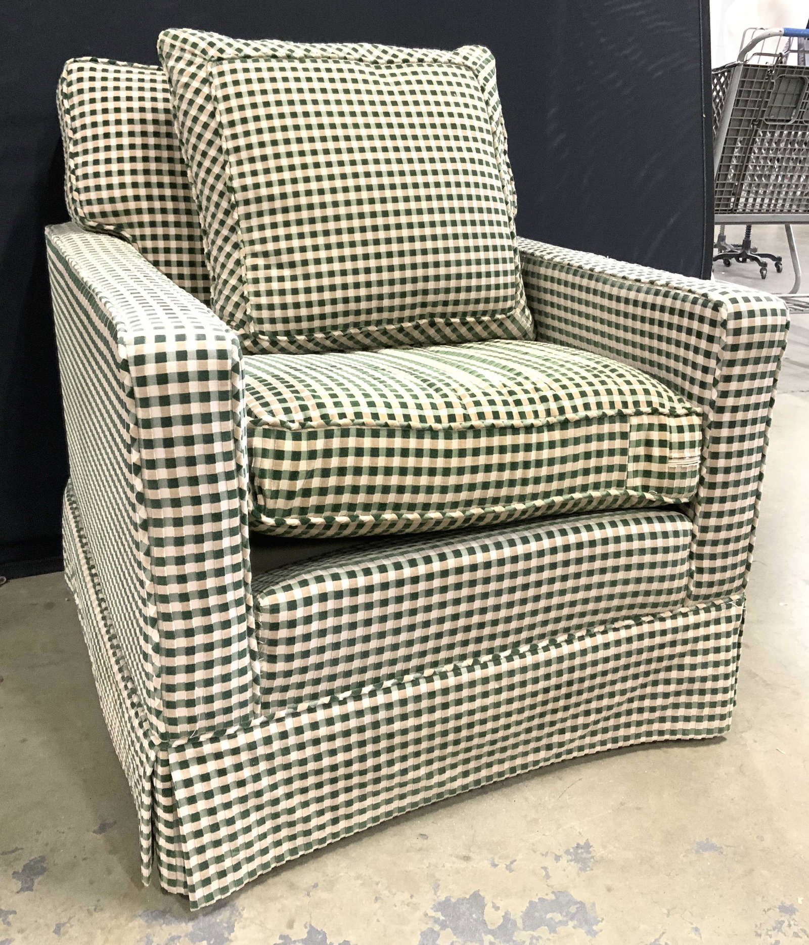 Vintage Skirted Checkered Armchair: Armchair is vintage. Piece has green and sand toned checkered upholstery. Chair is skirted. Lot includes matching pillow. Piec measures approx 37 inches tall 30 inches wide 35 inches deep. Chair, armc