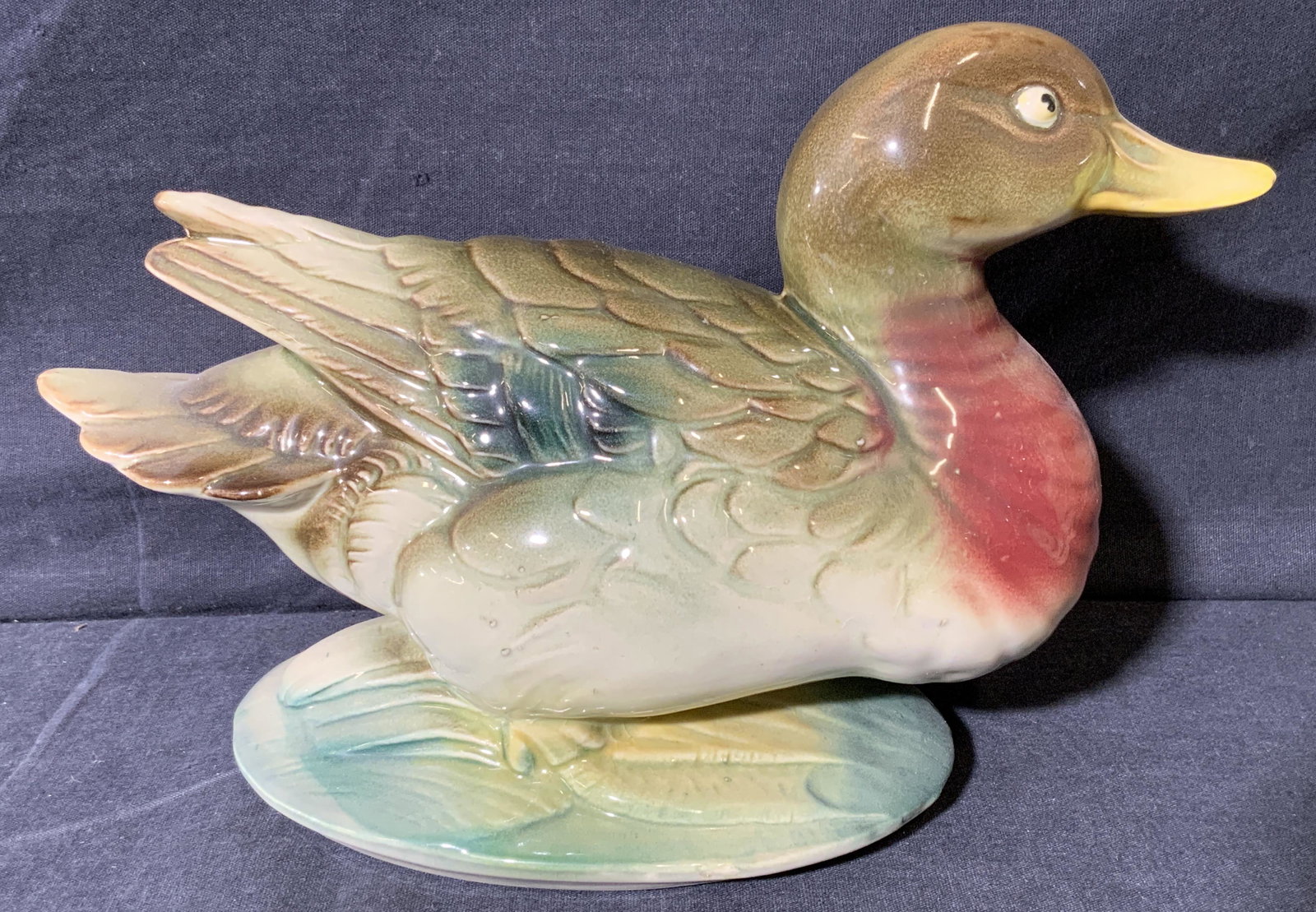 Ceramic Duck Statue: Ceramic Duck Statue, no apparent inscriptions or marks to piece, subject a green and red toned duck, measures 6 1/2 x 9 1/2 x 4 inches, surface wear to piece. Artwork, fine art, tabletop art, tabletop