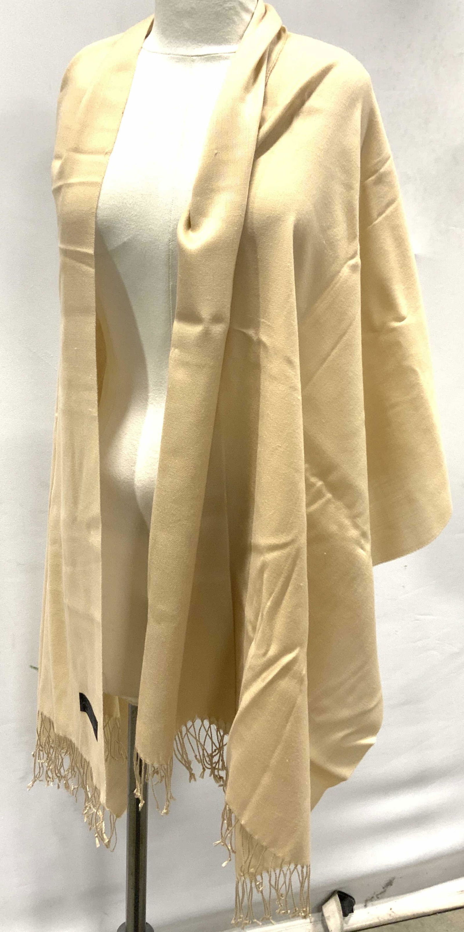 Fringed Pashmina Blend Shawl: Fringed shawl, fringes are knotted. Label reads as ‘70% Pashmina, 20% Wool, 10% Acrylic, Made in Nepal, Hand Wash Dry Clean’. Sand/beige toned. Wear is consistent with age and use. Measures approx