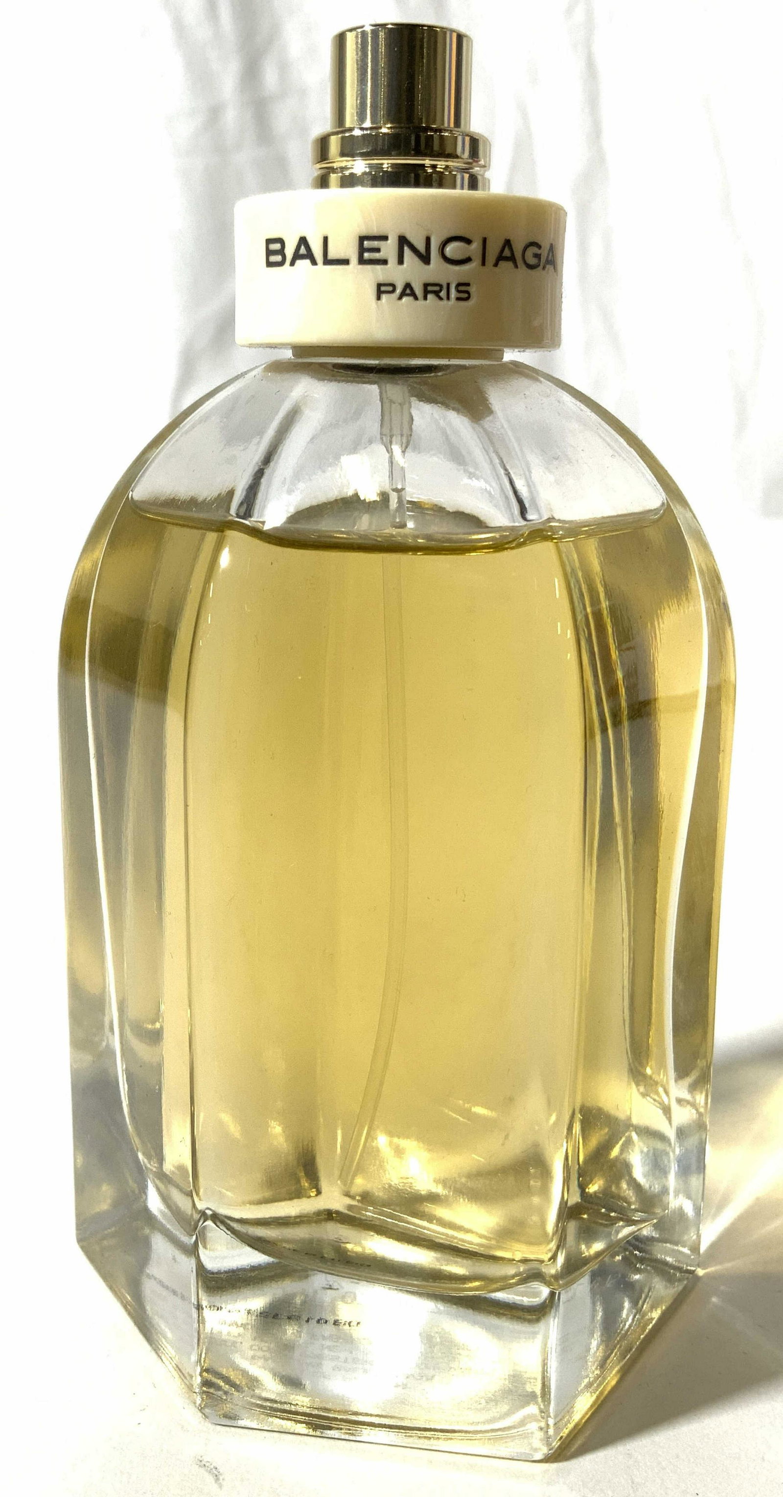 BALENCIAGA PARIS Perfume In Bottle: Top of bottle reads BALENCIAGA. Bottle is partially full. Piece includes trademarked black toned pouch. Perfume bottle measures approx 4.75 inches tall, 2.75 inches wide. Perfume, perfume in bottle, w