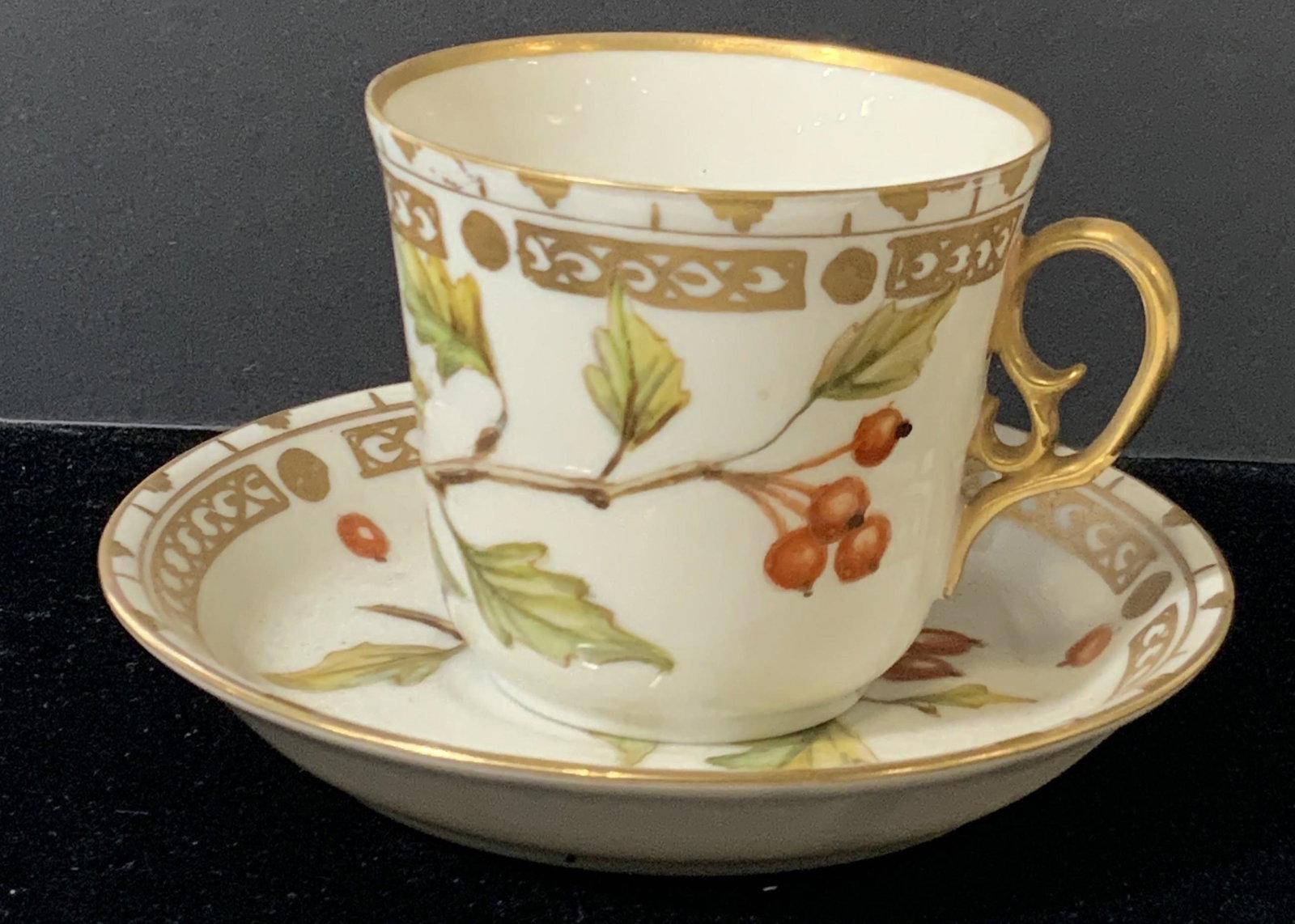 ROYAL COPENHAGEN Porcelain Tea cup & Saucer: A porcelain tea cup and saucer marked on undersides ‘Royal Copenhagen Denmark’ Tea cup and saucer both have gold gilt rims and accents designs in gold painted along the exterior rims of cup with g