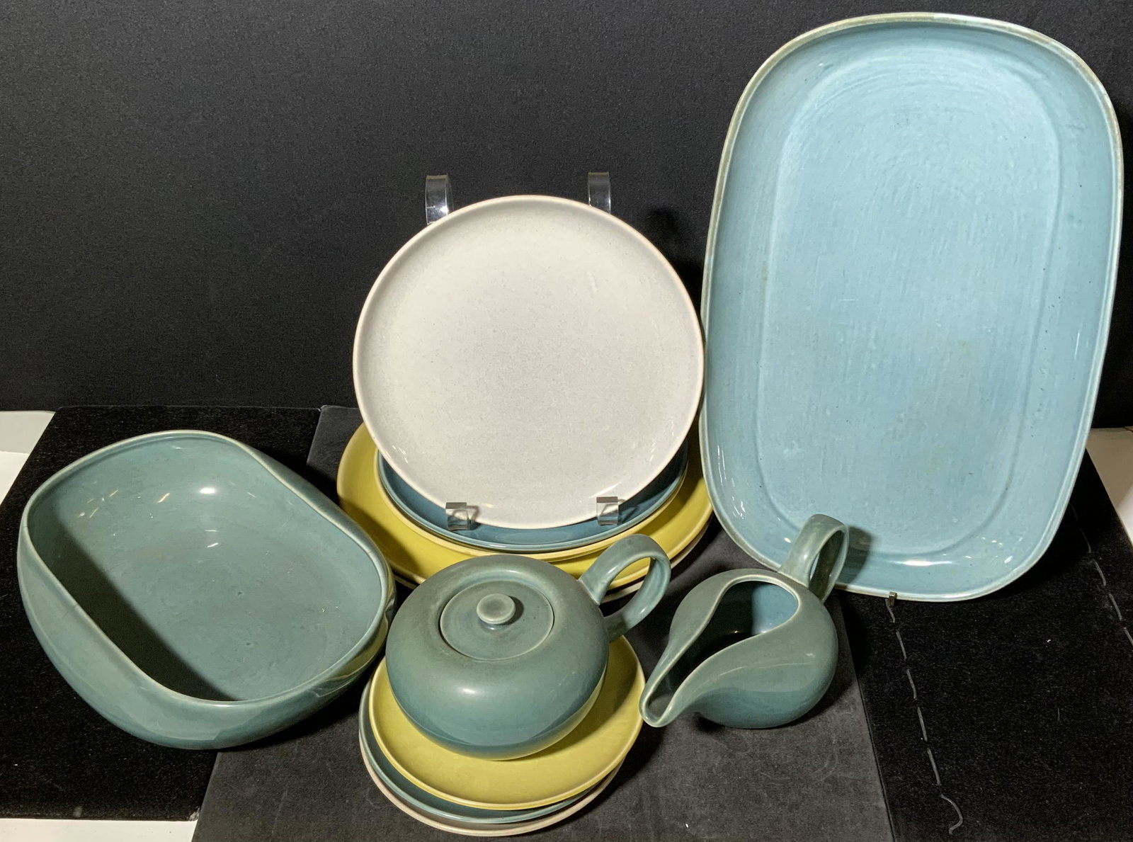 Group Lot RUSSEL WRIGHT Serving Ware: Group Lot 14 RUSSEL WRIGHT ceramic serving accessories. Includes 1 sauce boat, 3 luncheon plates, 2 dinner plates, 3 saucers, 2 tea cups, 1 rectangular platter, 1 lidded cup and 1 oval serving bowl. W