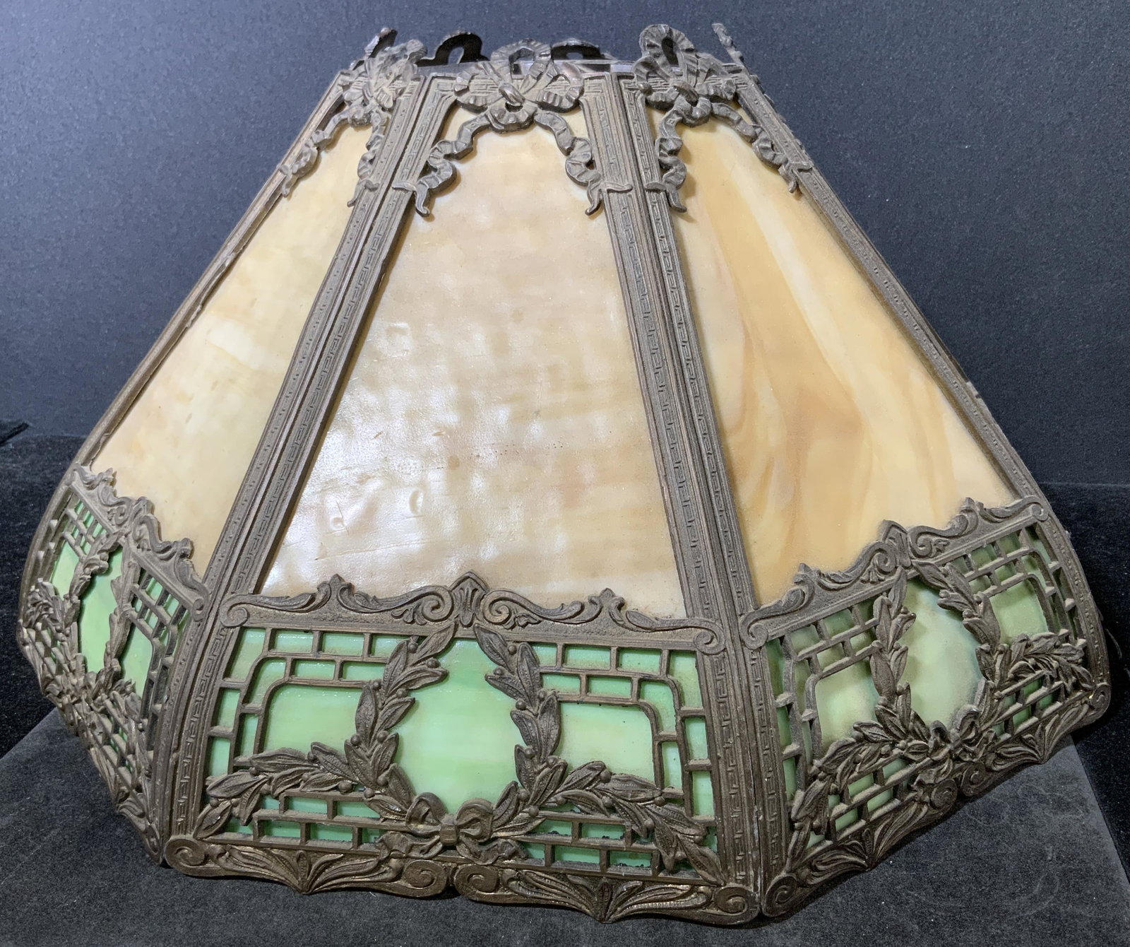 Vintage Slag Glass Lamp Shade: Vintage Slag Glass Lamp Shade. Possibly antique. Cream and lime green toned glass sections. Cast detailing resembles Laurel and ribbon like detailing. Wear is consistent with age and use, one of the c