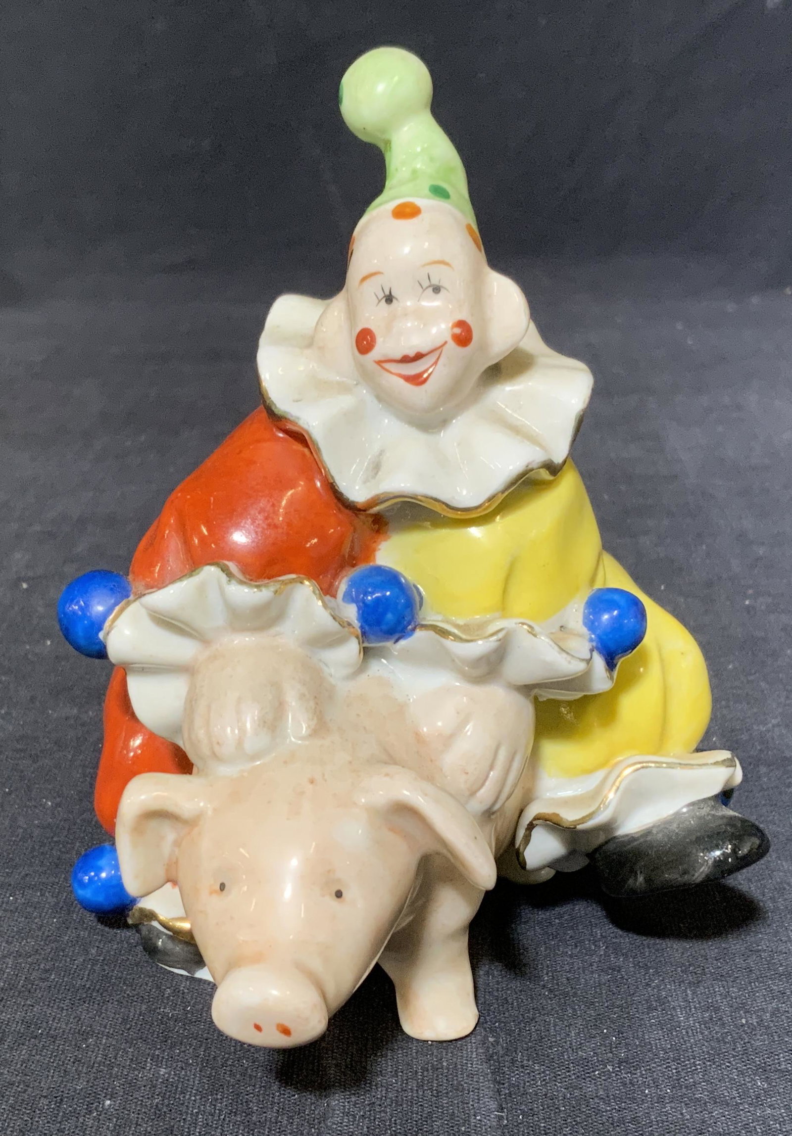 Hand Painted ORION Clown Figural: Hand painted figural. Depicts a clown riding a pig. Underside is marked ORION MADE IN JAPAN. Wear is consistent with age, surface wear present, wear to gilt paint. Measures approx 4.75 inches h, 4 inc