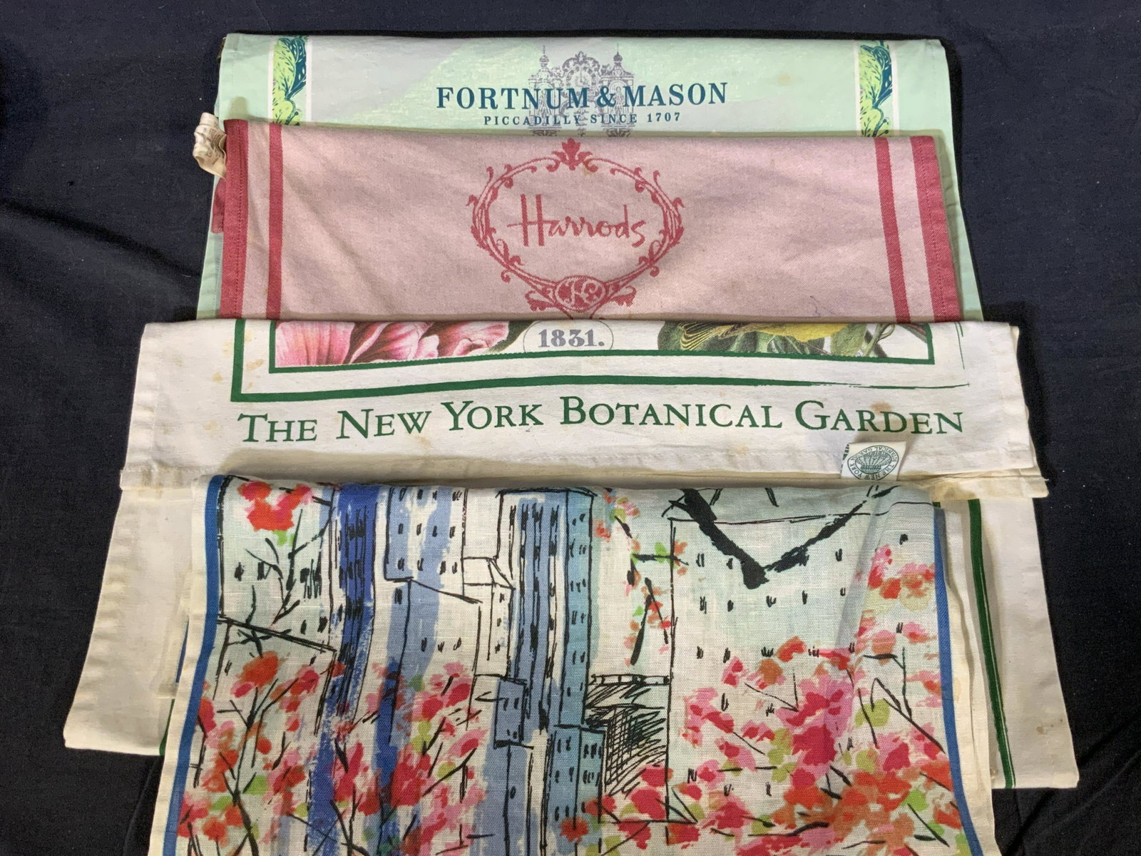 The MET, Harrods + Tea Towels: A group lot of 4 tea towels, one tagged â€˜Metropolitan Museum of Art, 100% linenâ€™ towel depicts a replica of Vera Newmannâ€™s work â€˜Central Parkâ€™ portraying a ink paintin