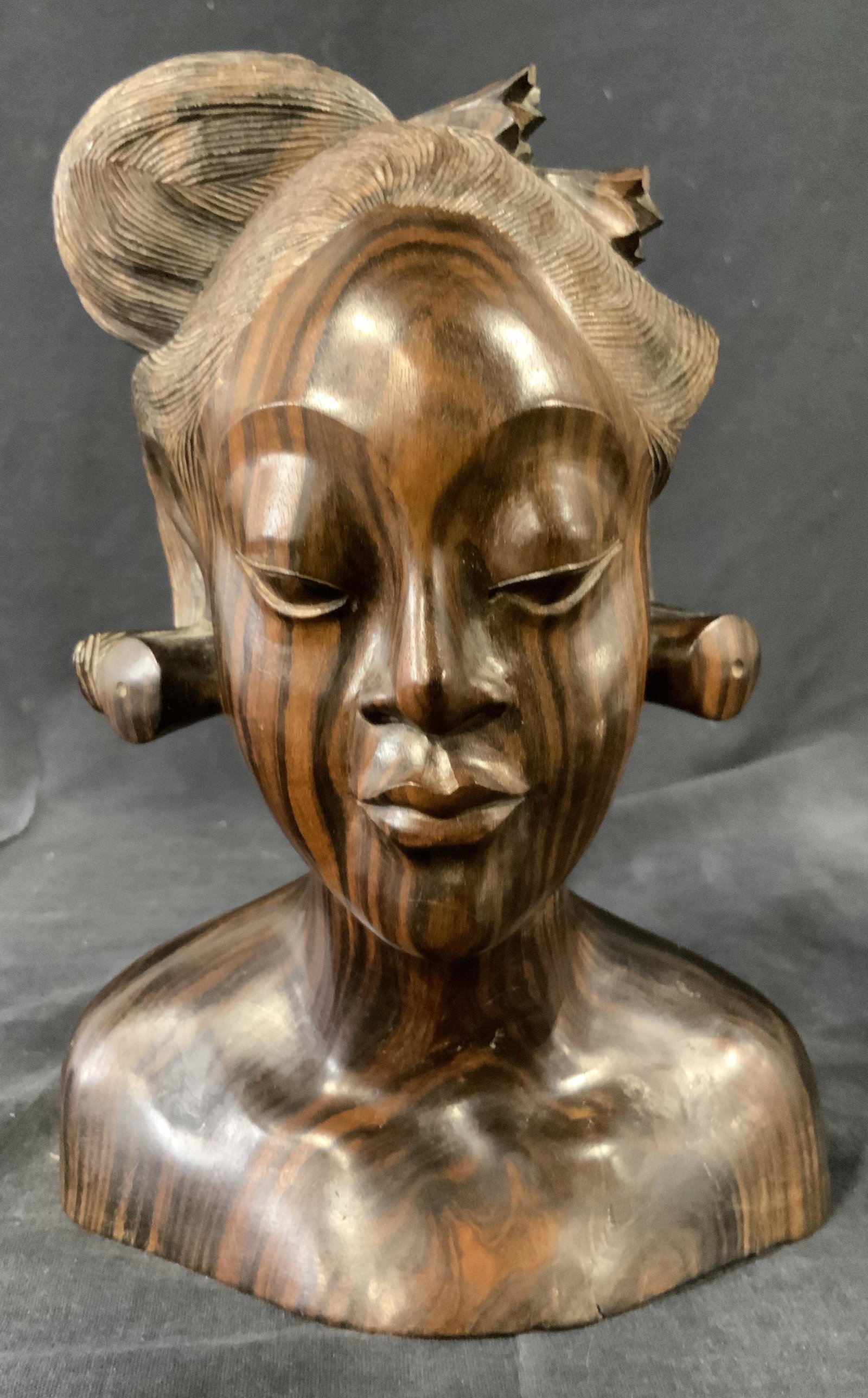 Hand carved Wooden Bust of Woman, Bali: Hand carved wooden bust of a women wearing traditional Balinese hairstyle, handcrafted in Bali. High detail in face and hair. Engraving on verso reads â€˜ Ida Bo Ral,â€™ â€˜Sanur Baliâ��