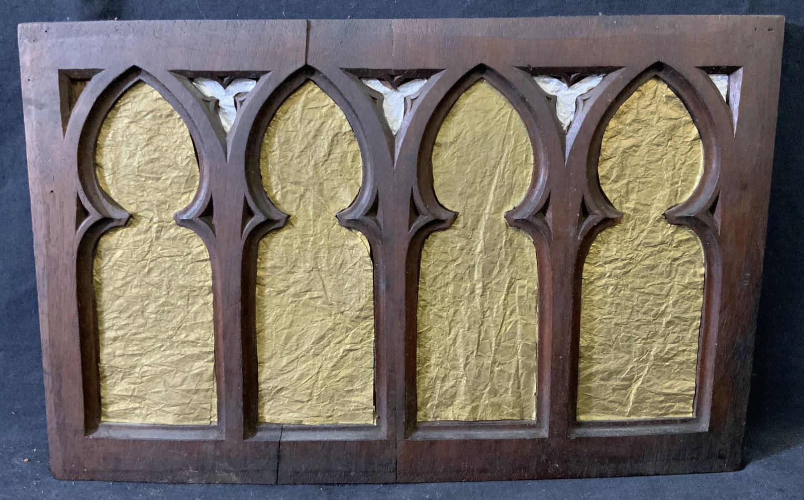 Vintage Gothic Wood Carving w/ Foil Paper: Vintage Gothic Wood Carving w/ Gold and Silver Toned Foil Paper, no apparent inscriptions, subject four gothic style inlets on wood, measures 15 1/4 x 9 3/4 inches, wood relief with gold and silver to