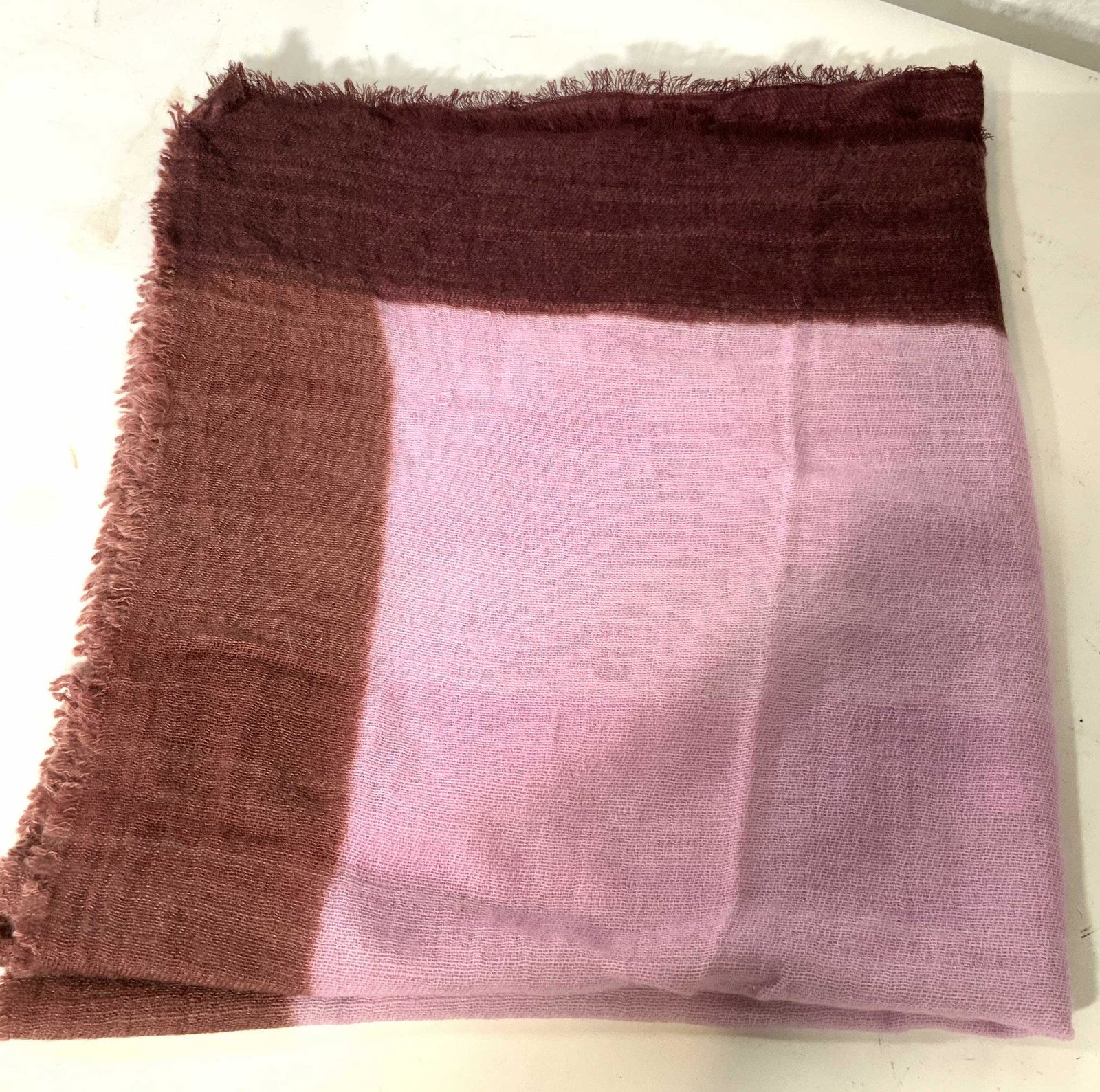 BAJRA Cashmere Pink & Red Scarf, Nepal: A Cashmere scarf with tag that reads â€˜Bajra Handmade in Nepal, 100% Cashmereâ€™ with a light purple and magenta threading. Approximately 72 in long and 35 in wide. Some pulled threading. Wo