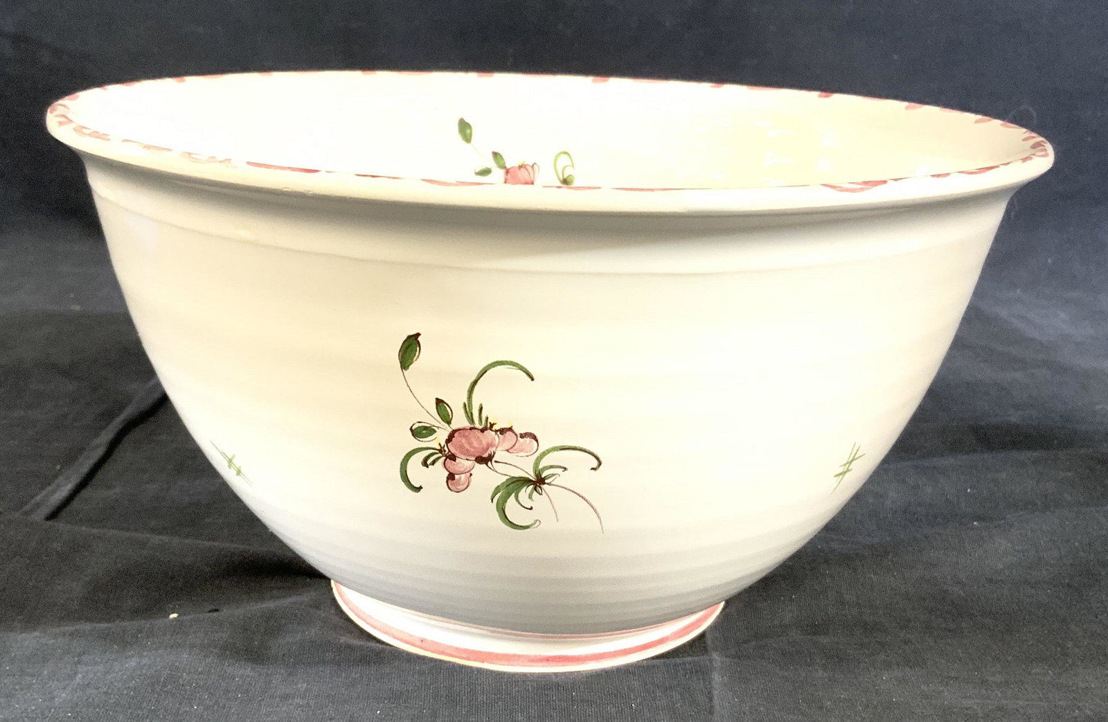 ATELIER MOUSTIERS Footed Porcelain Bowl: Underside of bowl is marked ATELIER AUCOGNET a MOUSTIERS. Bowl is white toned with multi toned floral and leaf detail. Bowl measures approx 5 inches tall 9.5 inches wide. Bowl, porcelain bowl, moustie