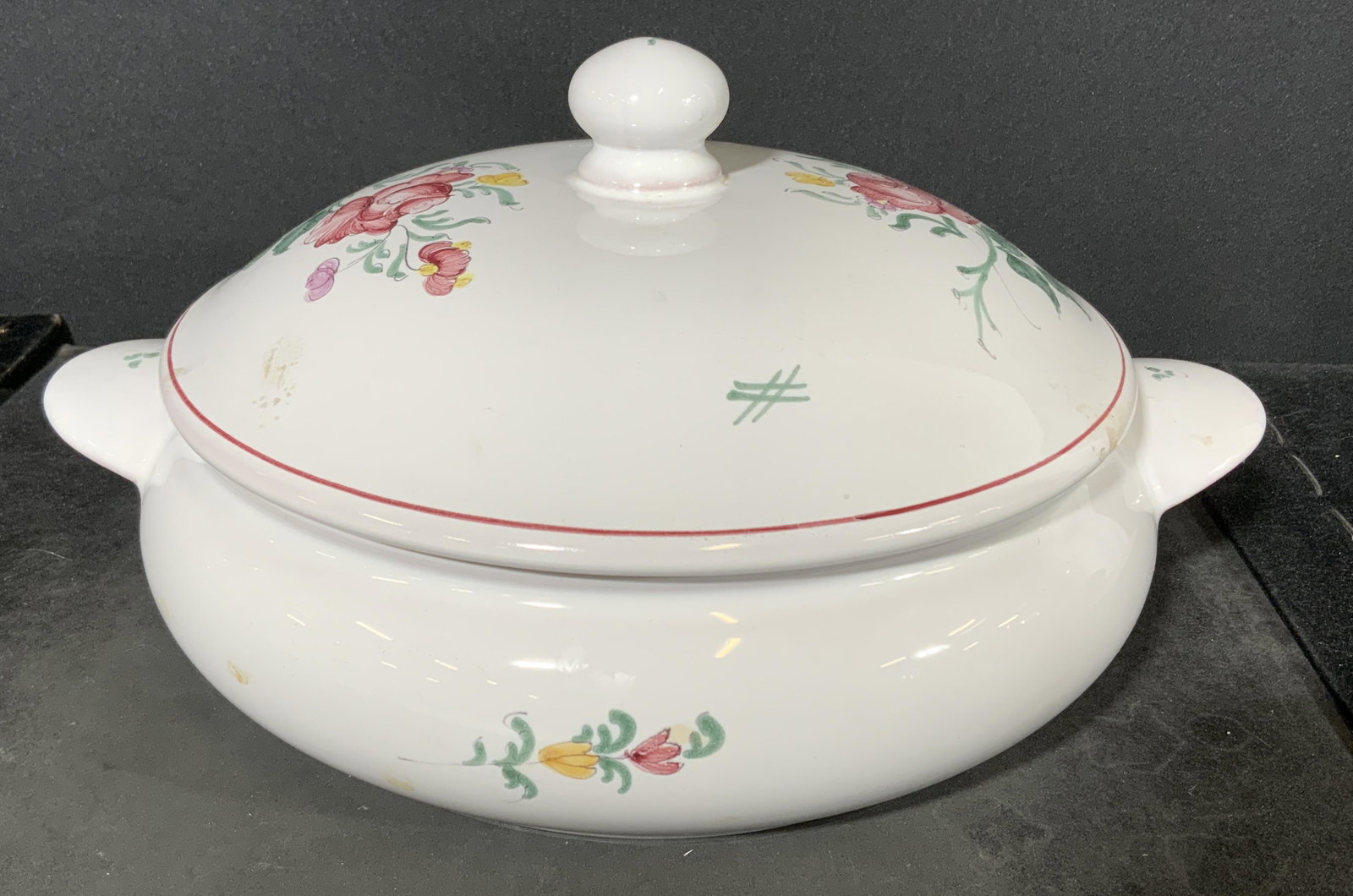 ATELIER DE SEGRIES Faience Tureen: Underside of tureen is marked ATELIER DE SEGRIES a MOUSTIERS FRANCE DY 539. Piece is white toned with multi toned floral and leaf detail. White glaze over earthenware. Piece measures approx 5 inches t